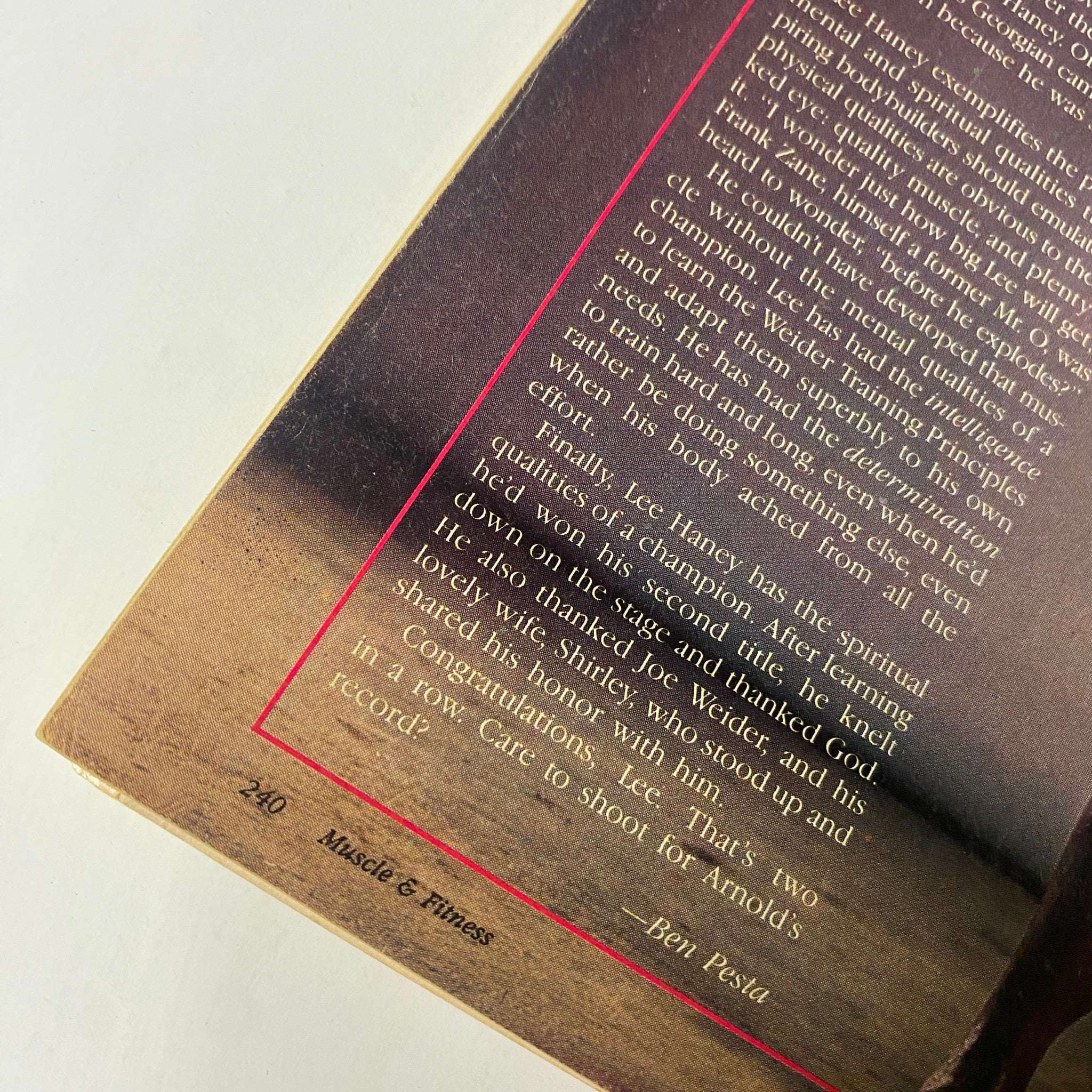 Close-up of text from 'The Champ' article about Lee Haney in Muscle & Fitness Magazine February 1986, celebrating his achievements and qualities.