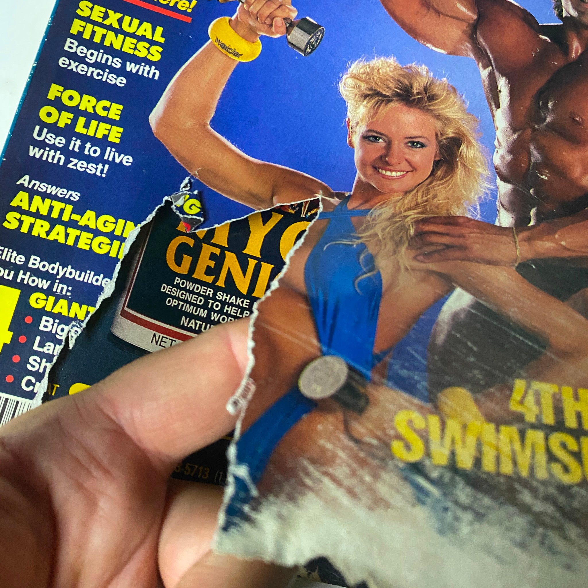 Close-up of damage on the cover of Muscle & Fitness Magazine February 1989 Joe Bucci No Label, showing a tear and highlighting the magazine's vintage condition.