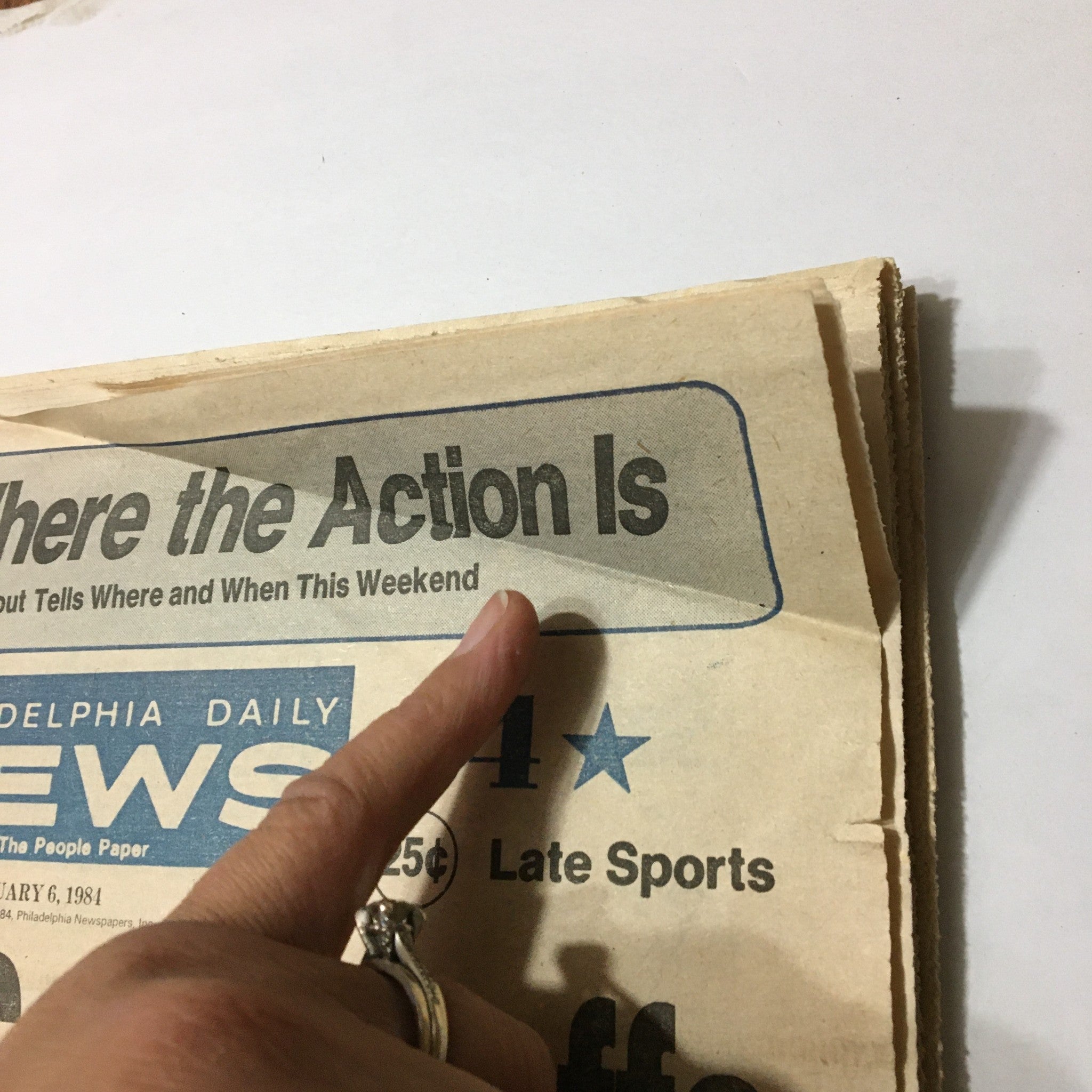 Close-up view of the Philadelphia Daily News dated January 6, 1984, highlighting the headline 'Where the Action Is', related to the sports events of that weekend.
