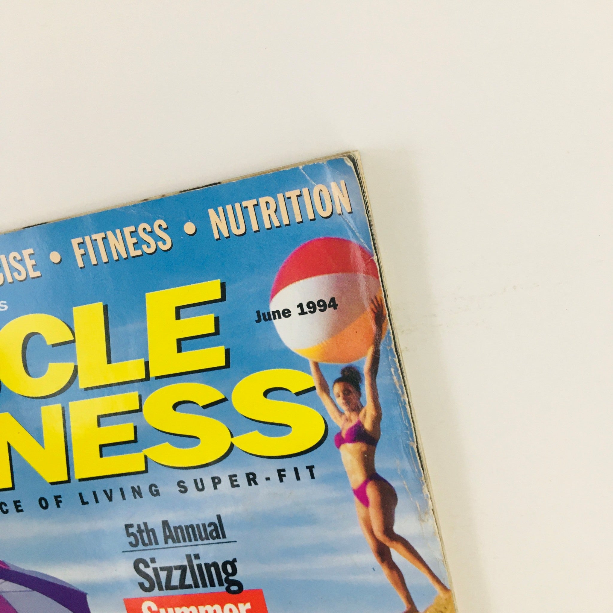 Close-up of the Muscle & Fitness Magazine June 1994 title, highlighting its focus on health and fitness.