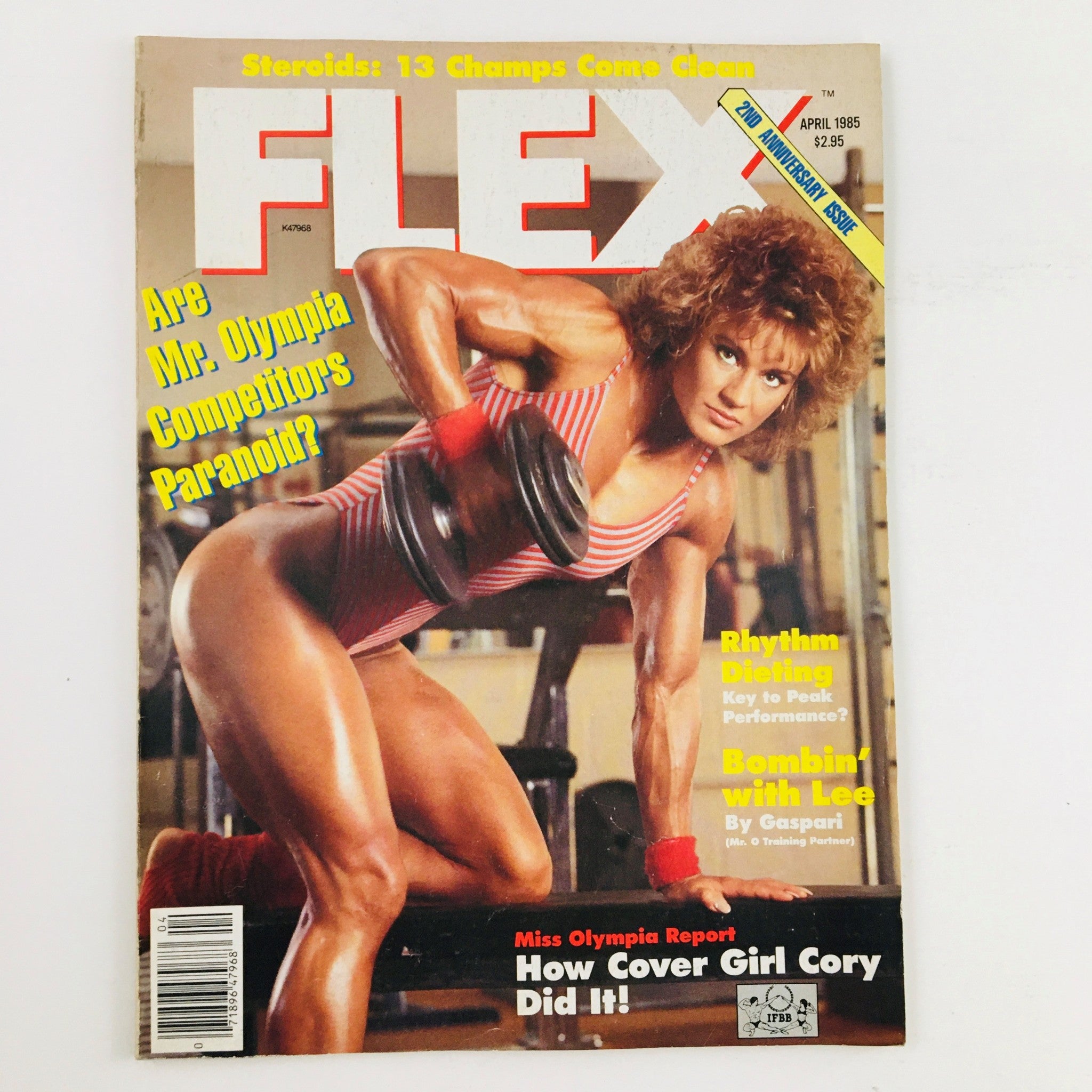 Joe Weider's Flex Magazine April 1985 Miss Olympia Cory Everson cover featuring Cory Everson showcasing her muscular physique while holding weights, representative of the bodybuilding culture in the 1980s.