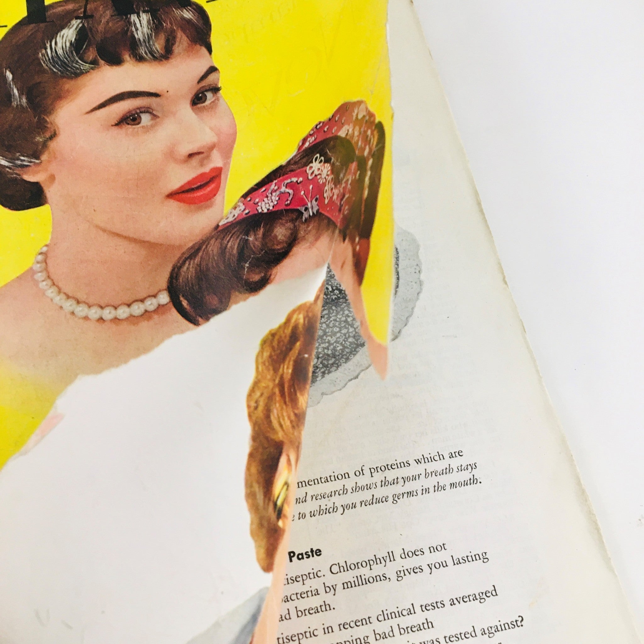 Inside page of Woman's Home Companion April 1954, showcasing an article with a focus on a woman with a pearl necklace and vintage hairstyle.