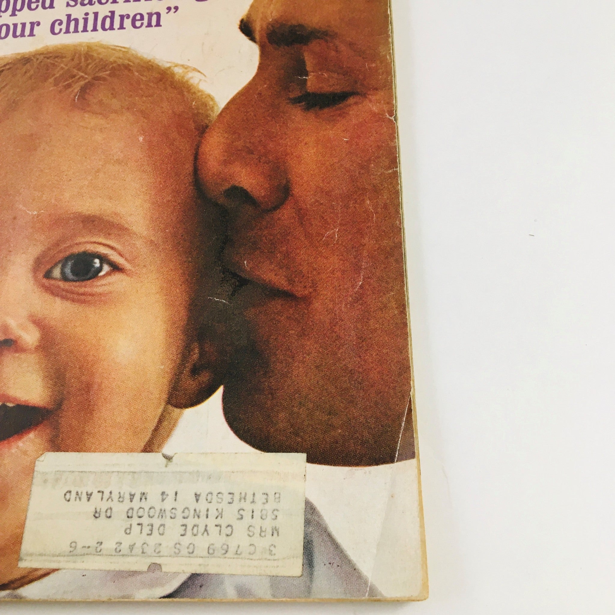 Side view of the cover of Redbook Magazine June 1962 showing a smiling baby, with a man embracing him, reflecting the familial themes discussed in the issue.