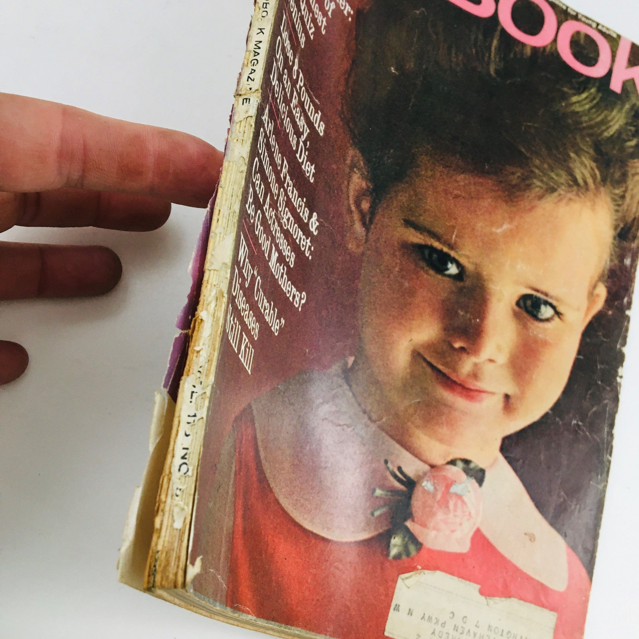 Side view of Redbook Magazine March 1962 showing the binding and wear, highlighting the nostalgic quality of vintage publications. The cover includes the article 'Teddy Nadler: Tragedy of An Honest TV Quiz Genius'.