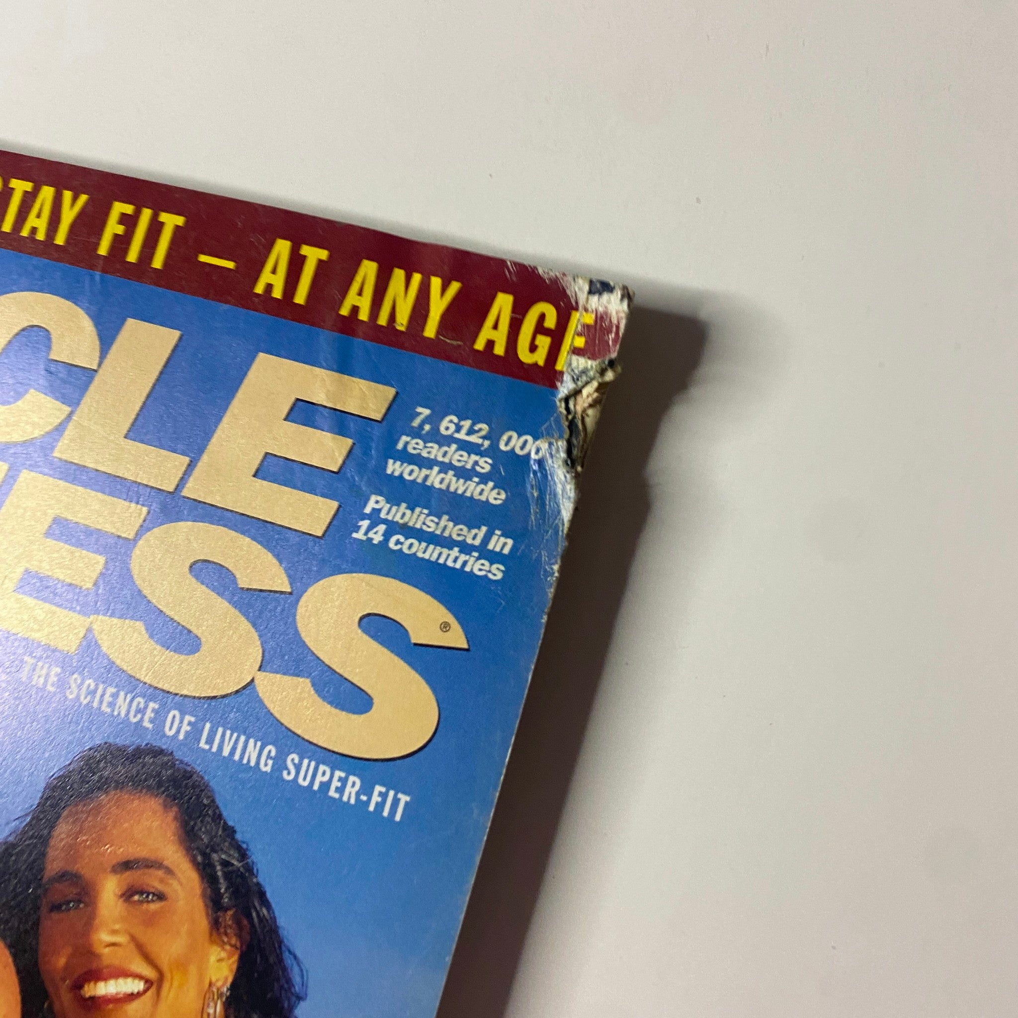 Corner detail of the June 1995 Muscle & Fitness Magazine showcasing wear and tear, highlighting the magazine's vintage condition.