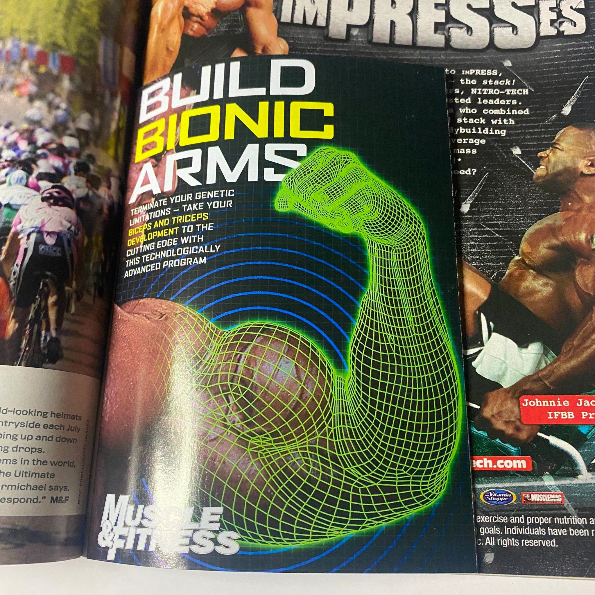 Advertisement in Muscle & Fitness Magazine December 2003 promoting 'Build Bionic Arms' program with a graphic representation of muscular arms.