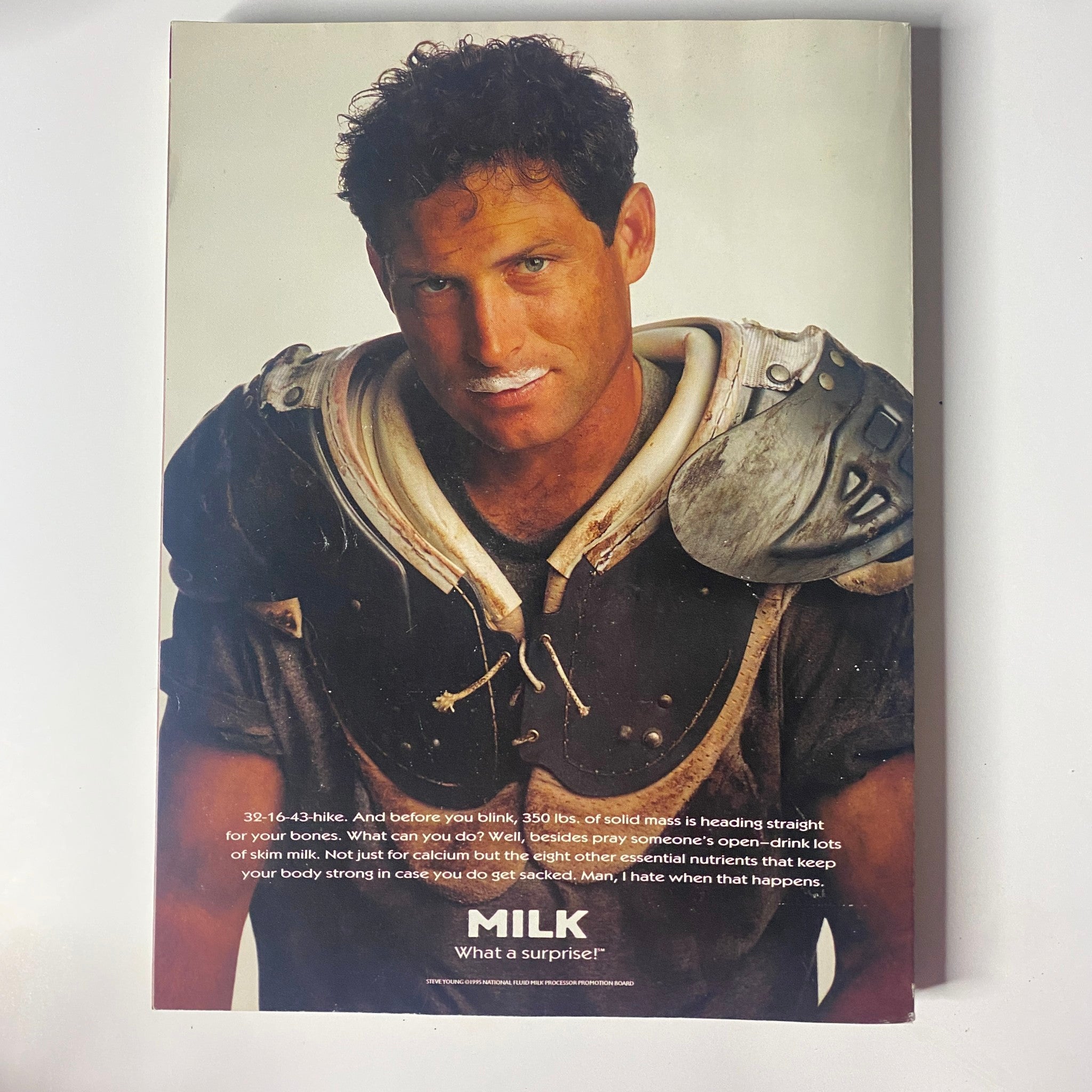 Back cover of Muscle & Fitness Magazine August 1996, featuring a football player with a milk mustache, promoting the benefits of milk for strong bones and nutrition.