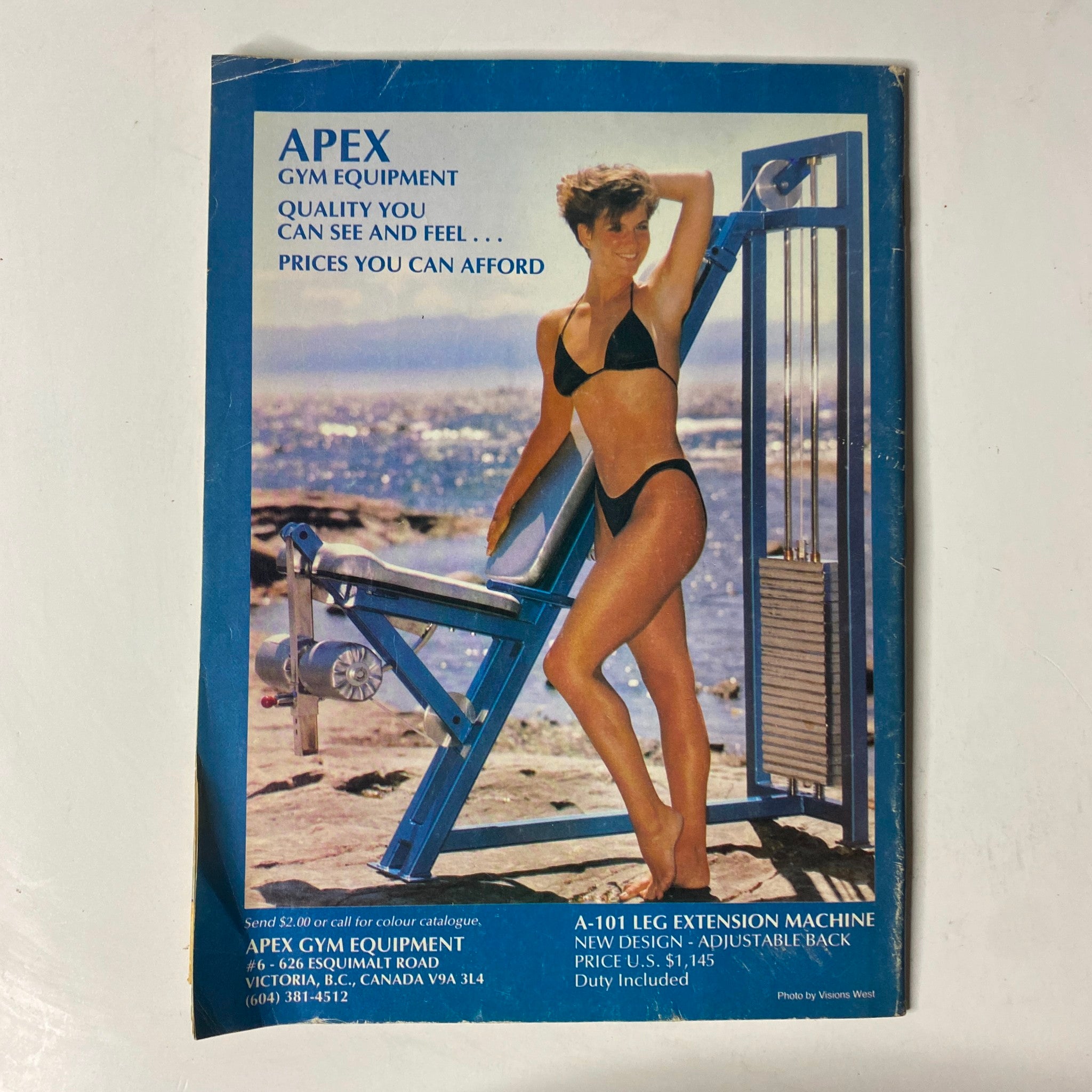 Apex Gym Equipment advertisement featuring a woman in a bikini posing next to a leg extension machine. The ad promotes quality gym equipment with the tagline 'Quality you can see and feel... Prices you can afford.' This image is relevant to the November 1988 issue of MuscleMag International Magazine No. 79 featuring Bob Paris.