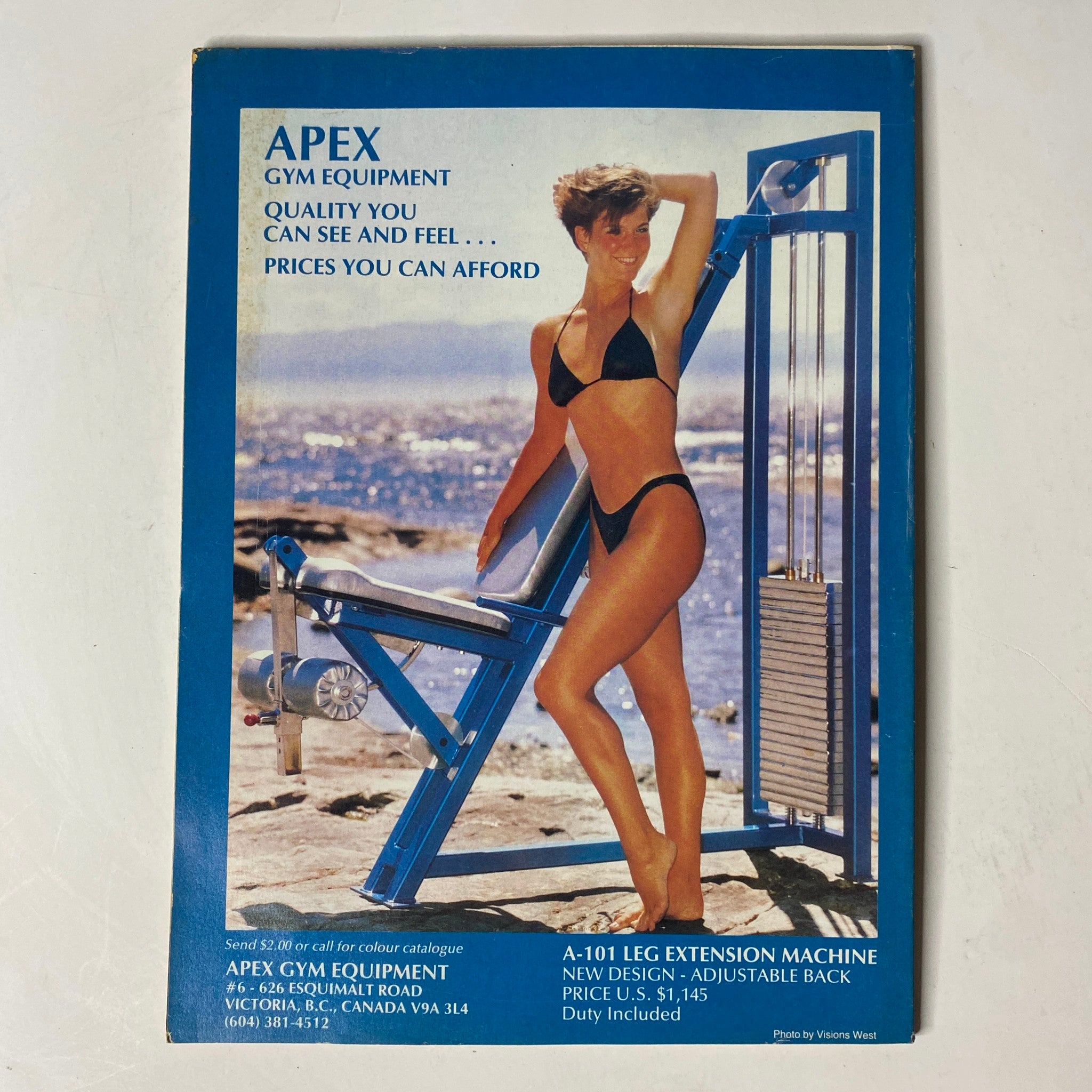 MuscleMag International Magazine May 1989 No. 84 featuring Shawn Ray on the cover, showcasing Apex Gym Equipment advertisement with a model posing with fitness equipment, promoting quality and affordability in gym products.