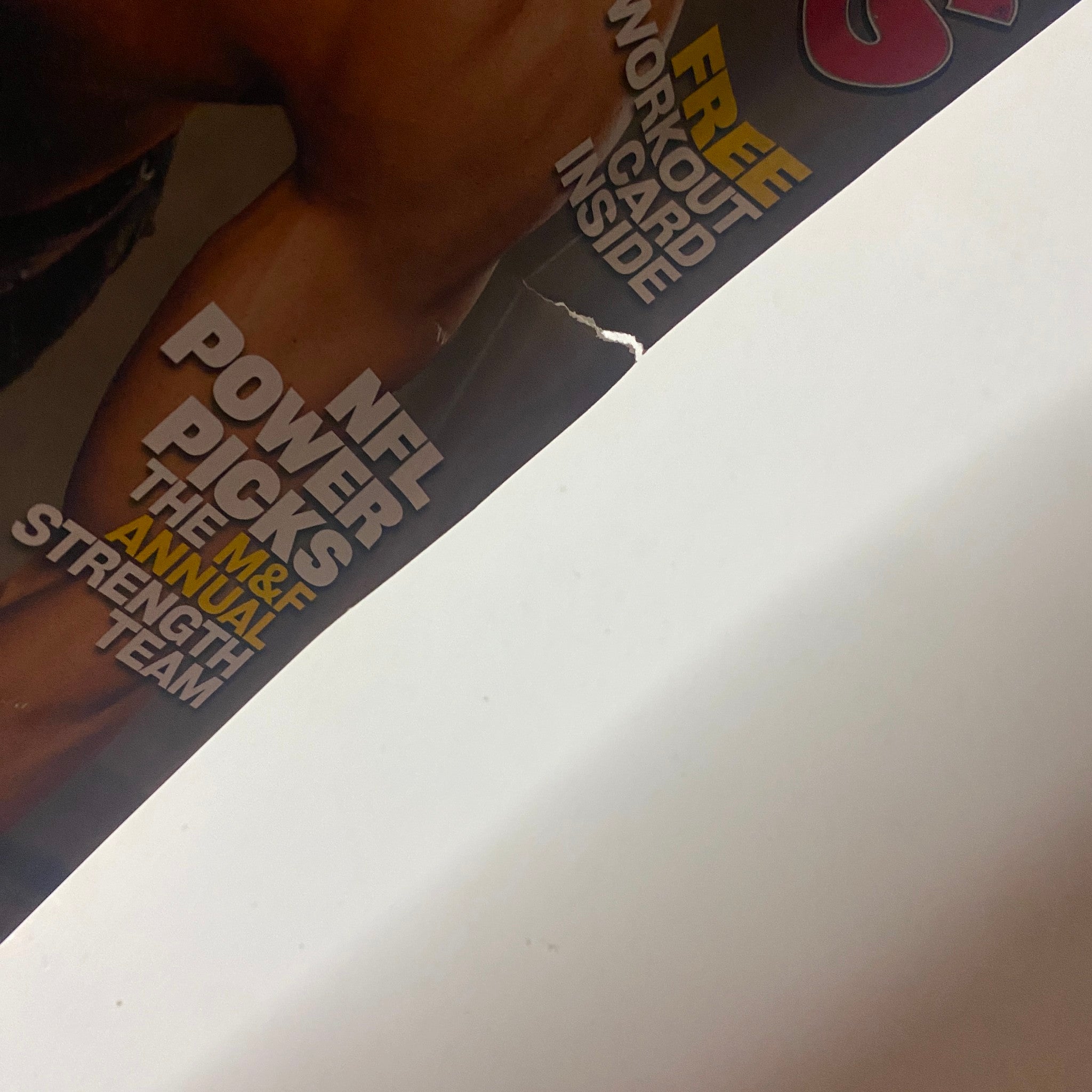 Cover detail of Muscle & Fitness Magazine October 2003 Vol 64 No. 10 featuring NFL Power Picks and workout card inside. A vintage bodybuilding magazine with a torn edge visible.
