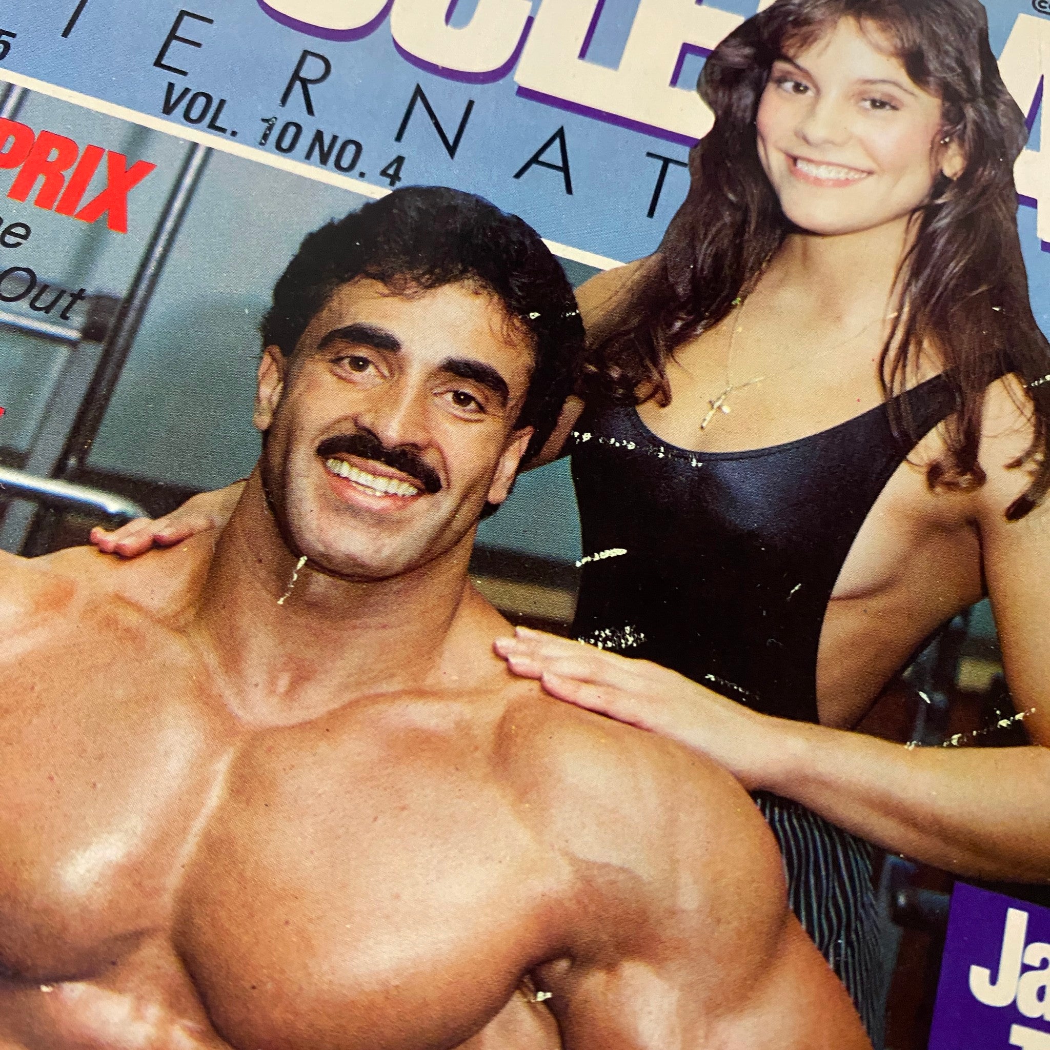 Close-up of the April 1985 MuscleMag International Magazine cover showing Samir Bannout and Lori Labratto, showcasing bodybuilding highlights and the Ms. Olympia competition.
