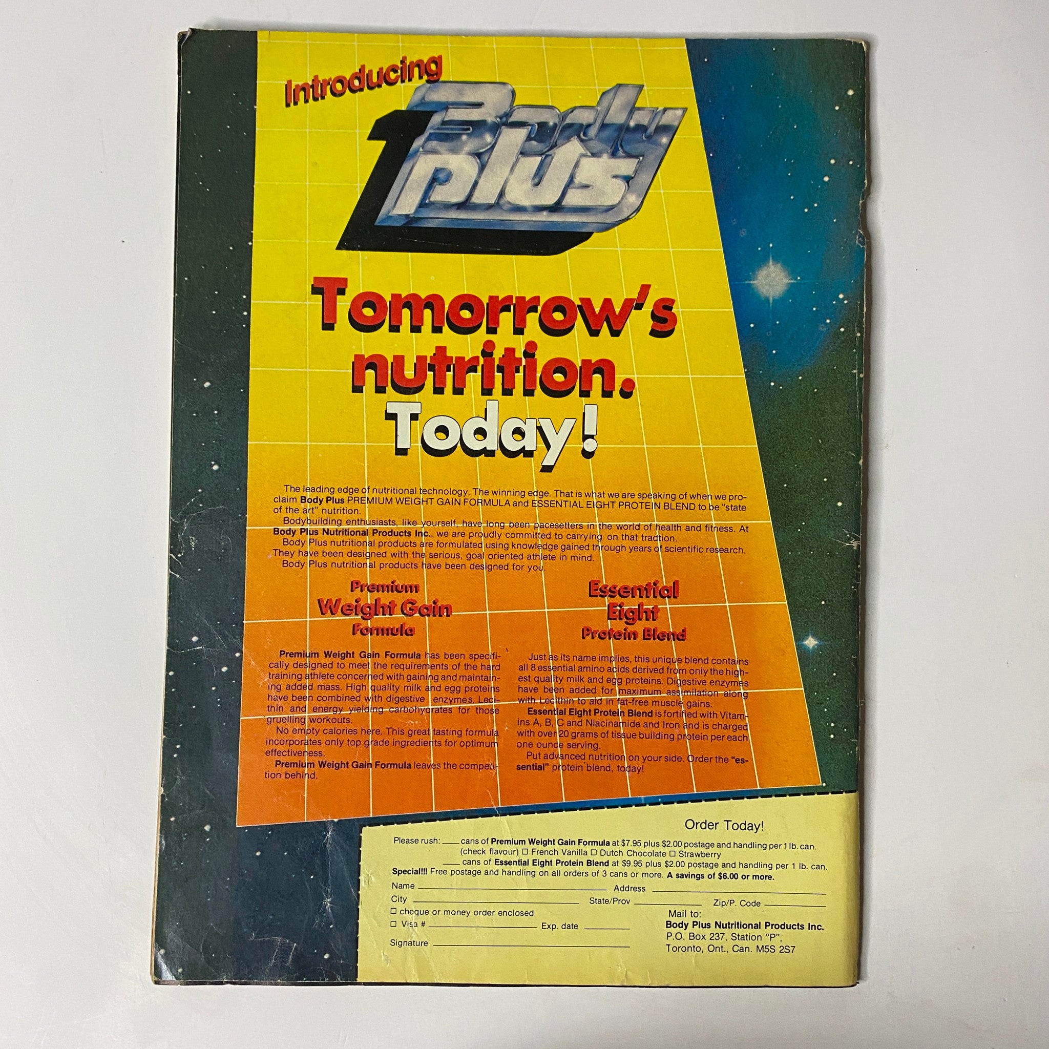 Back cover of the MuscleMag International Magazine May 1985 Vol 10 No 5 featuring a promotion for Body Plus nutrition products, highlighting premium weight gain and essential protein blend formulas.