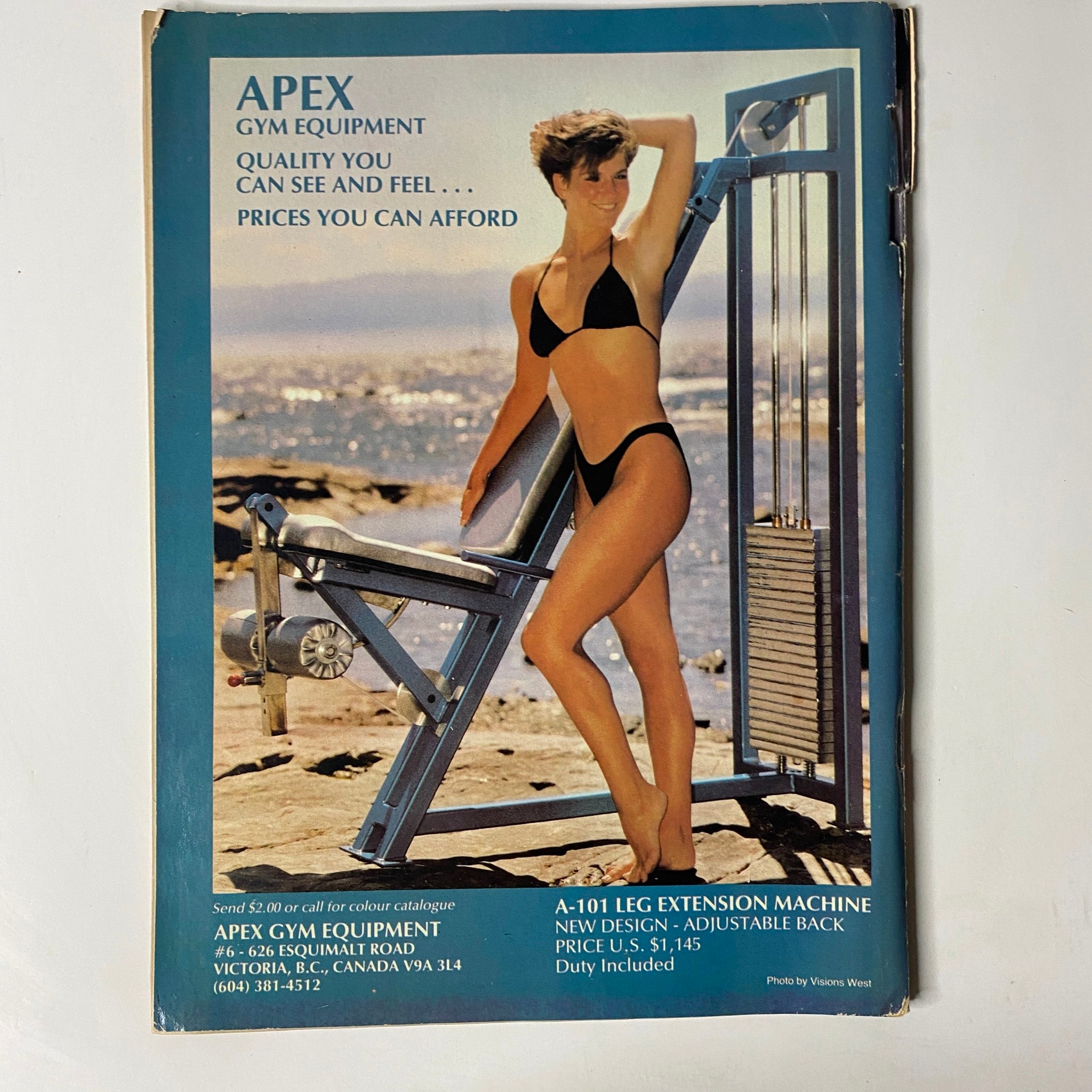MuscleMag International Magazine June 1986 back cover featuring an advertisement for APEX Gym Equipment, showcasing a model in a bikini demonstrating a leg extension machine, emphasizing fitness and bodybuilding themes.