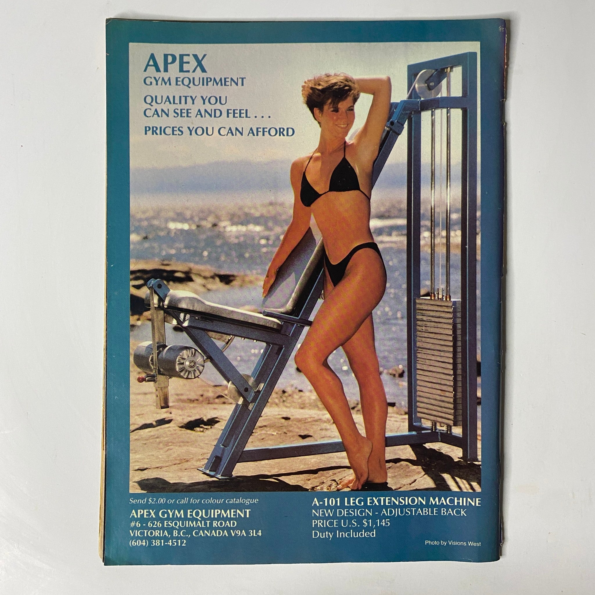 Back cover of MuscleMag International Magazine August 1986 promoting Apex Gym Equipment with a model in a bikini demonstrating a leg extension machine, offering an eye-catching end to the bodybuilding issue.