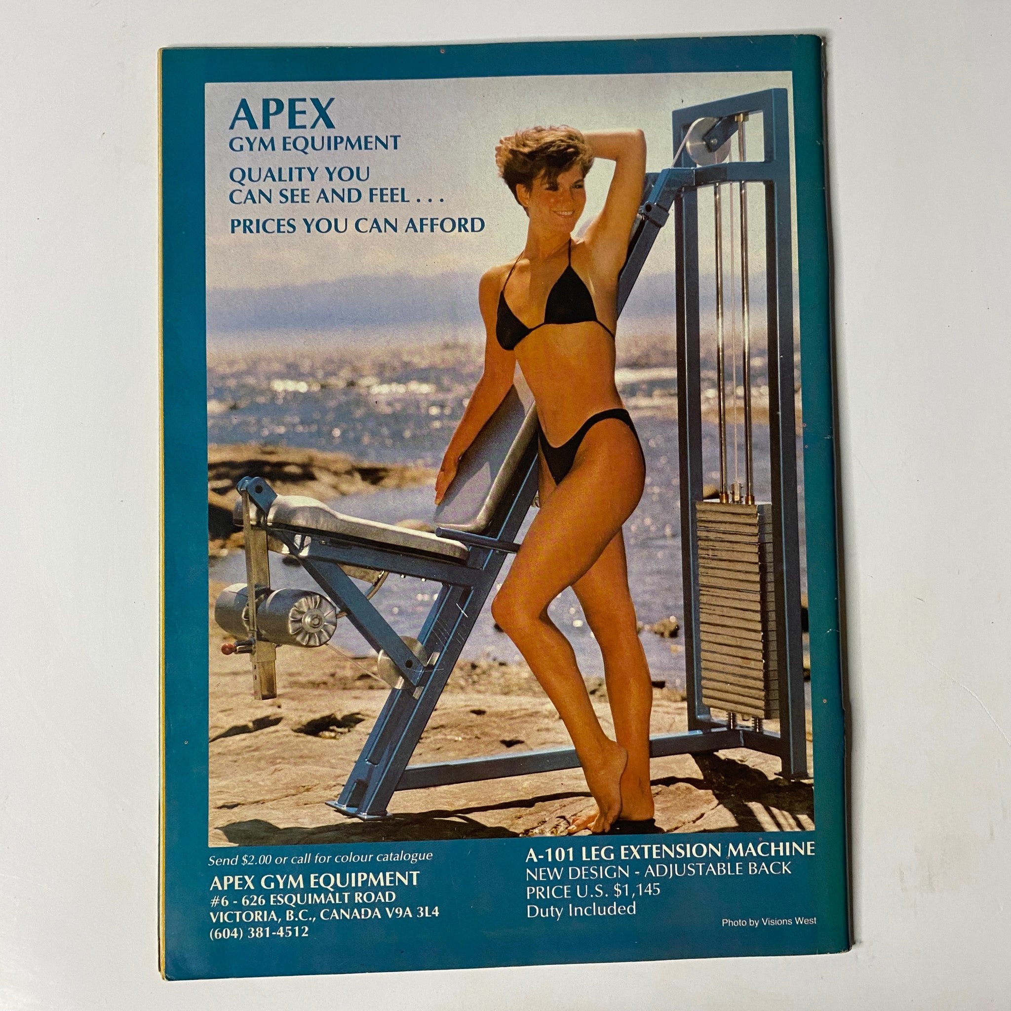 Advertisement for Apex Gym Equipment featured in MuscleMag International Magazine March 1987 No. 64, showcasing a woman in a bikini with gym equipment, promoting fitness and quality.