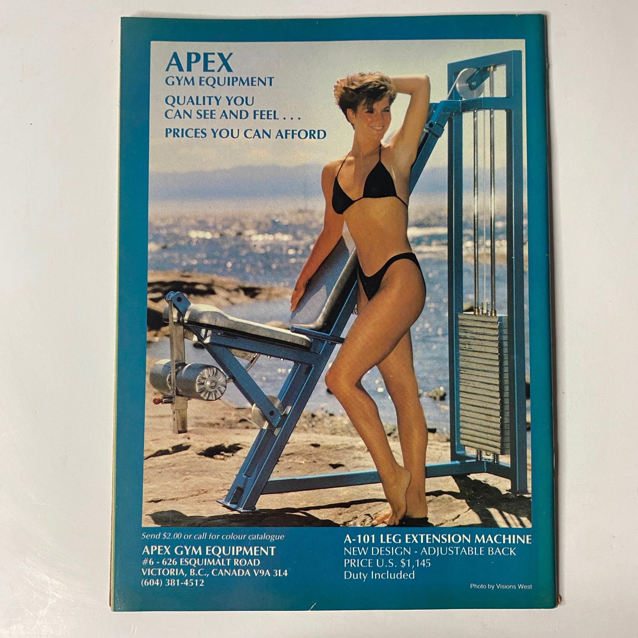 Cover of MuscleMag International Magazine May 1987 No. 65 featuring David and Peter Paul, known as 'The Barbarians', promoting Apex Gym Equipment with an attractive model demonstrating fitness equipment in a bikini.
