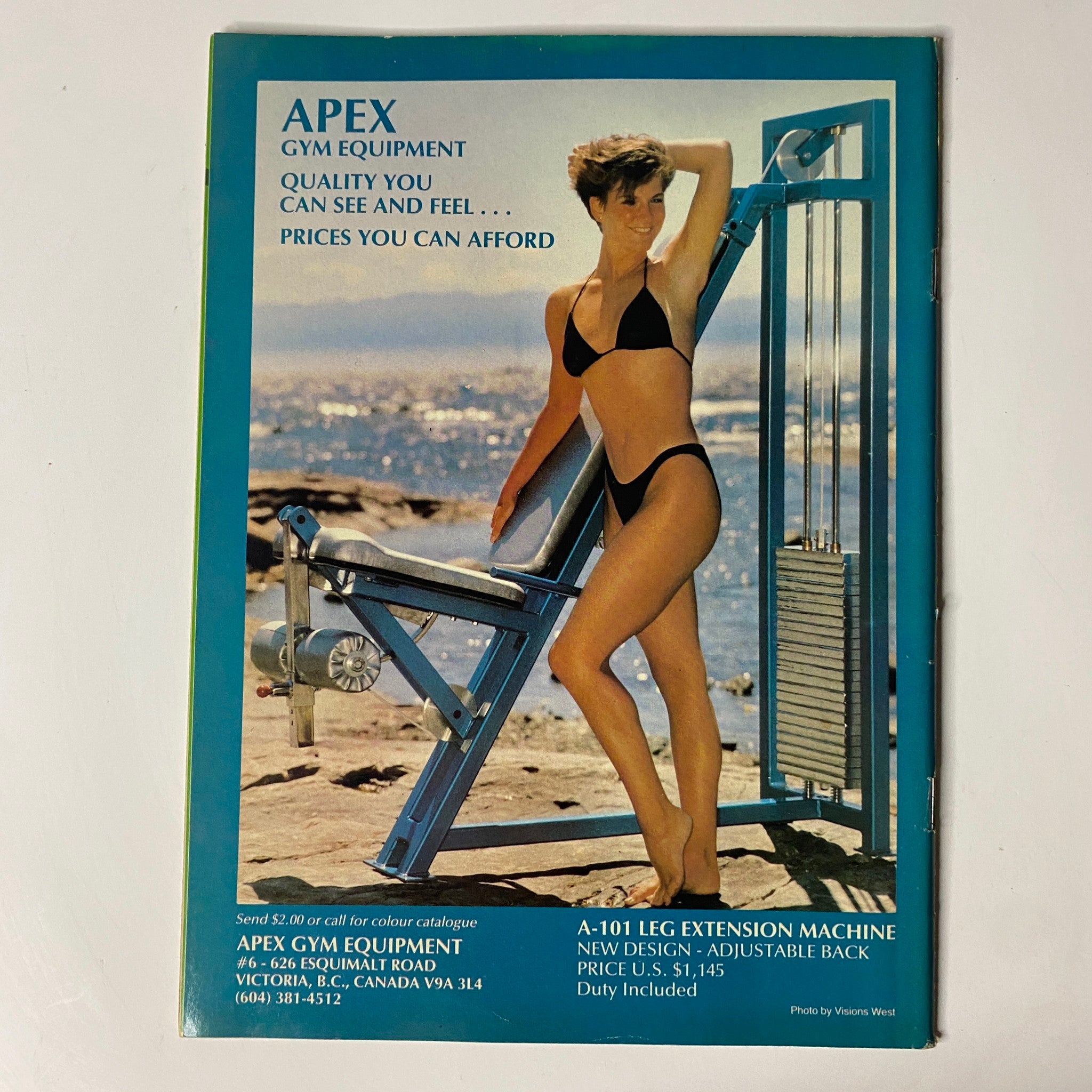 Advertisement for Apex Gym Equipment from the back cover of MuscleMag International Magazine May 1987 No. 65, showcasing fitness equipment for affordable prices with a model in a bikini.