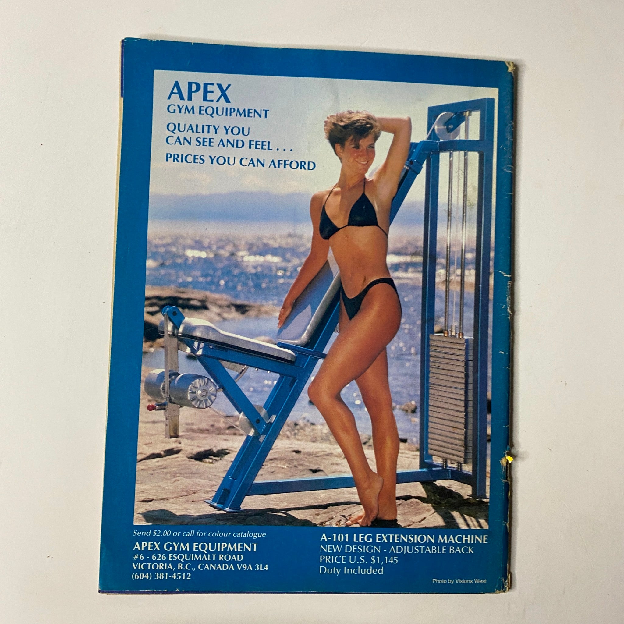 Back cover of MuscleMag International Magazine March 1988 No. 72 showcasing APEX gym equipment with a model in a bikini, emphasizing quality and accessibility of fitness equipment.