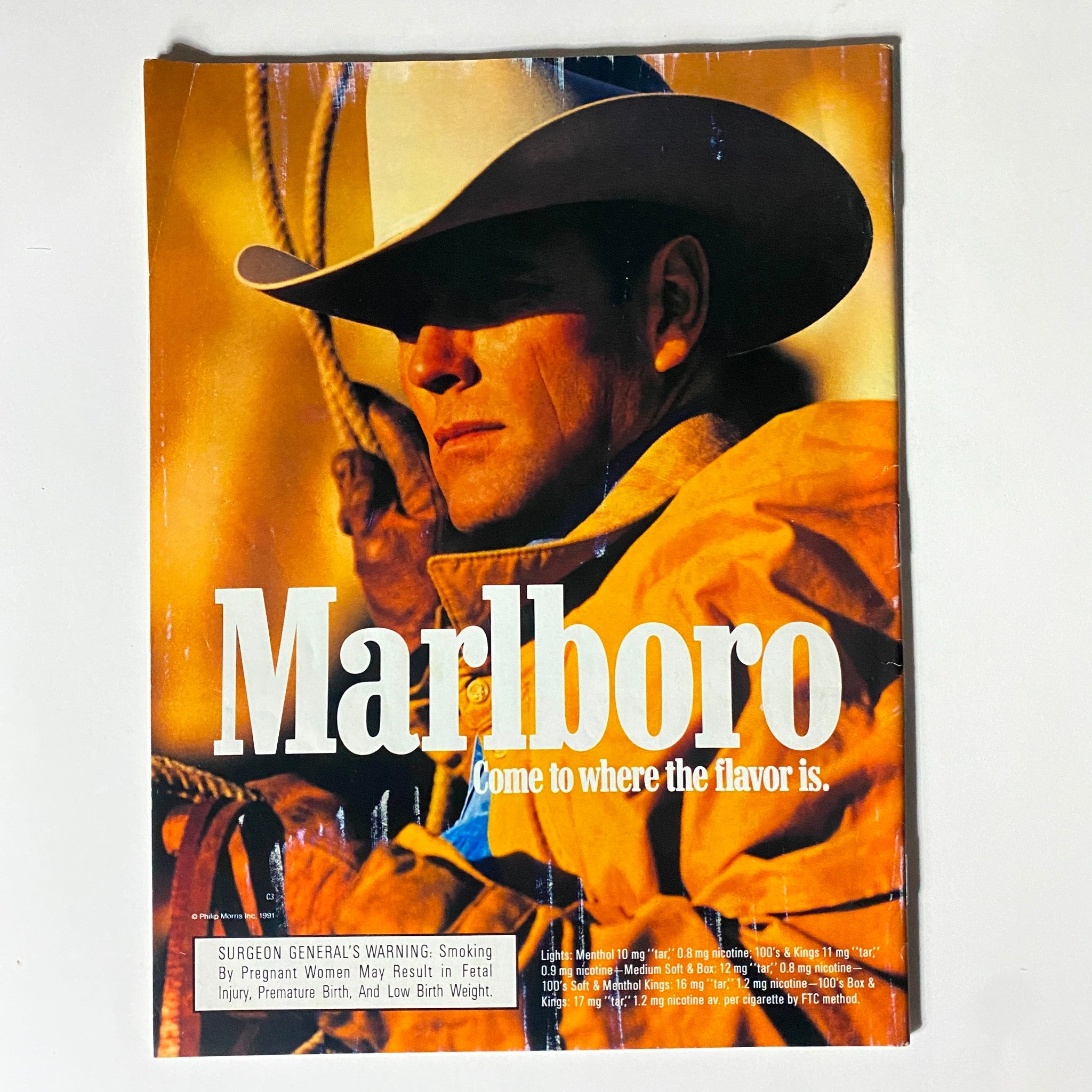 Cover of a Marlboro advertisement magazine featuring a cowboy in a wide-brimmed hat, promoting the tagline 'Come to where the flavor is'.