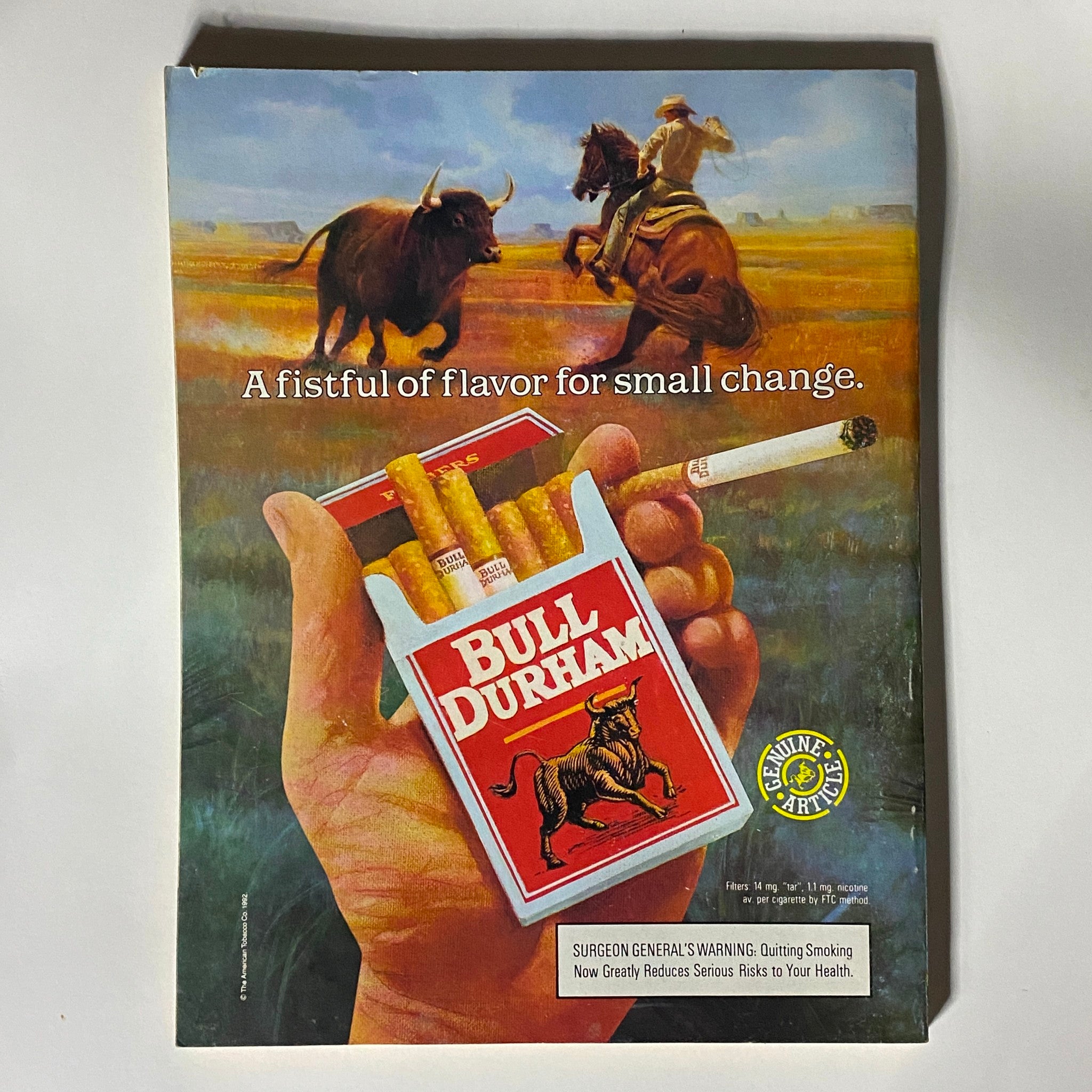 Vintage advertisement for Bull Durham cigarettes, featuring a hand holding a pack of cigarettes with a cowboy and buffalo in the background. This ad showcases a tagline promoting flavor at an affordable price. Relevant to the Street & Smith's Baseball Magazine 1992 Roger Clemens Boston Red Sox.