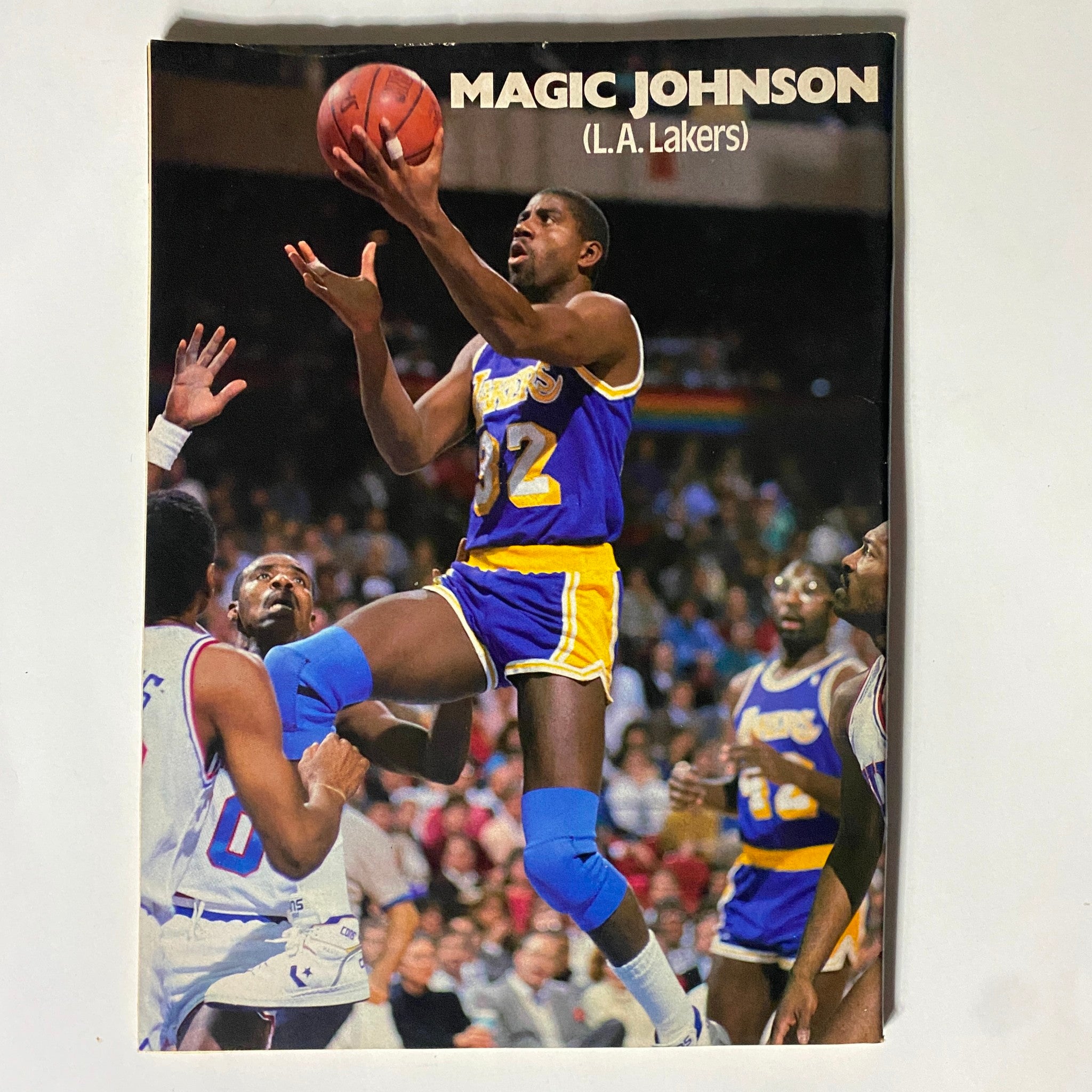 Feature of Magic Johnson in Pro Basketball Illustrated Magazine 1989-1990, capturing an action shot during a game with his Lakers uniform.
