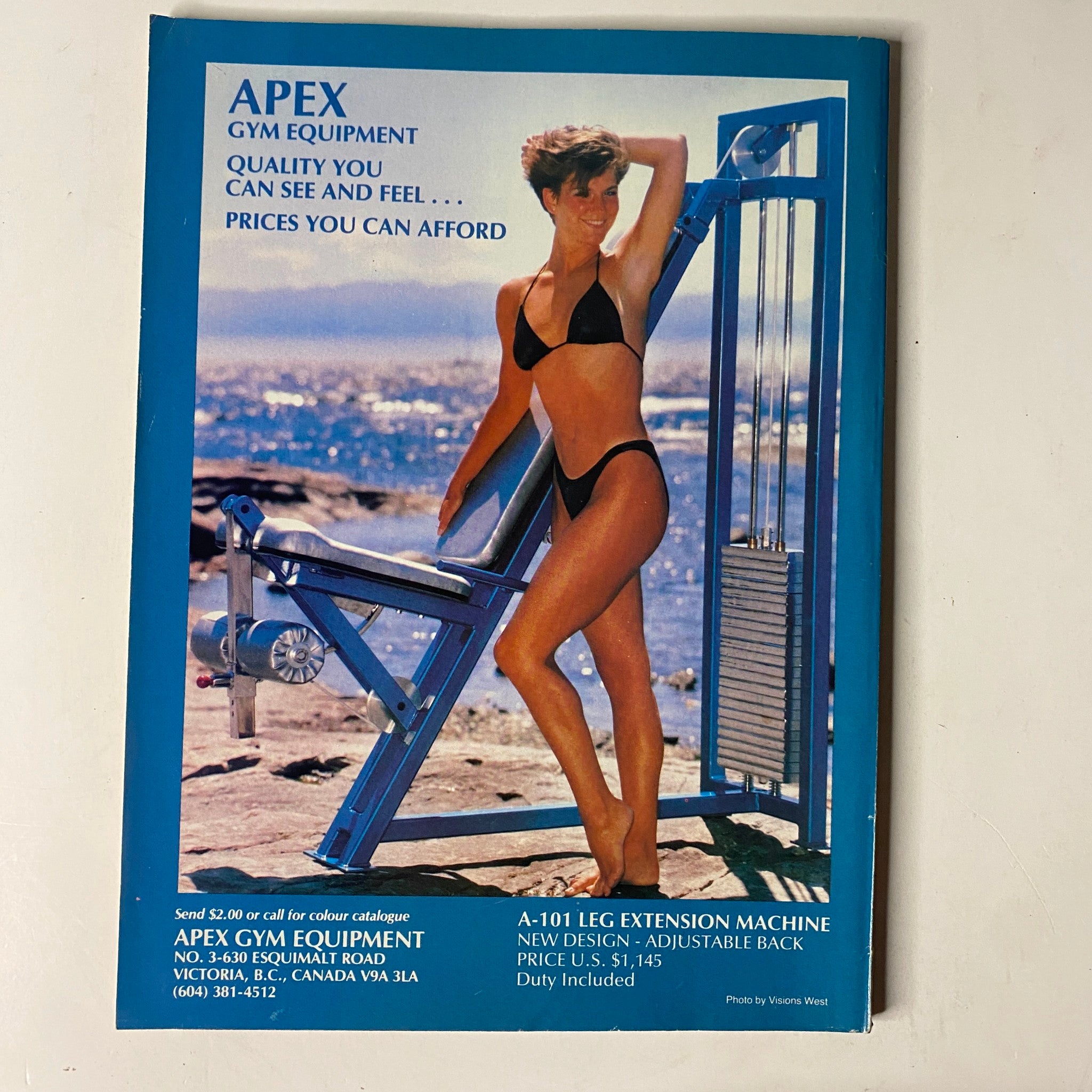 Advertisement for APEX gym equipment in MuscleMag International Magazine, April 1990, No. 95 featuring a model demonstrating a leg extension machine, emphasizing quality fitness products.