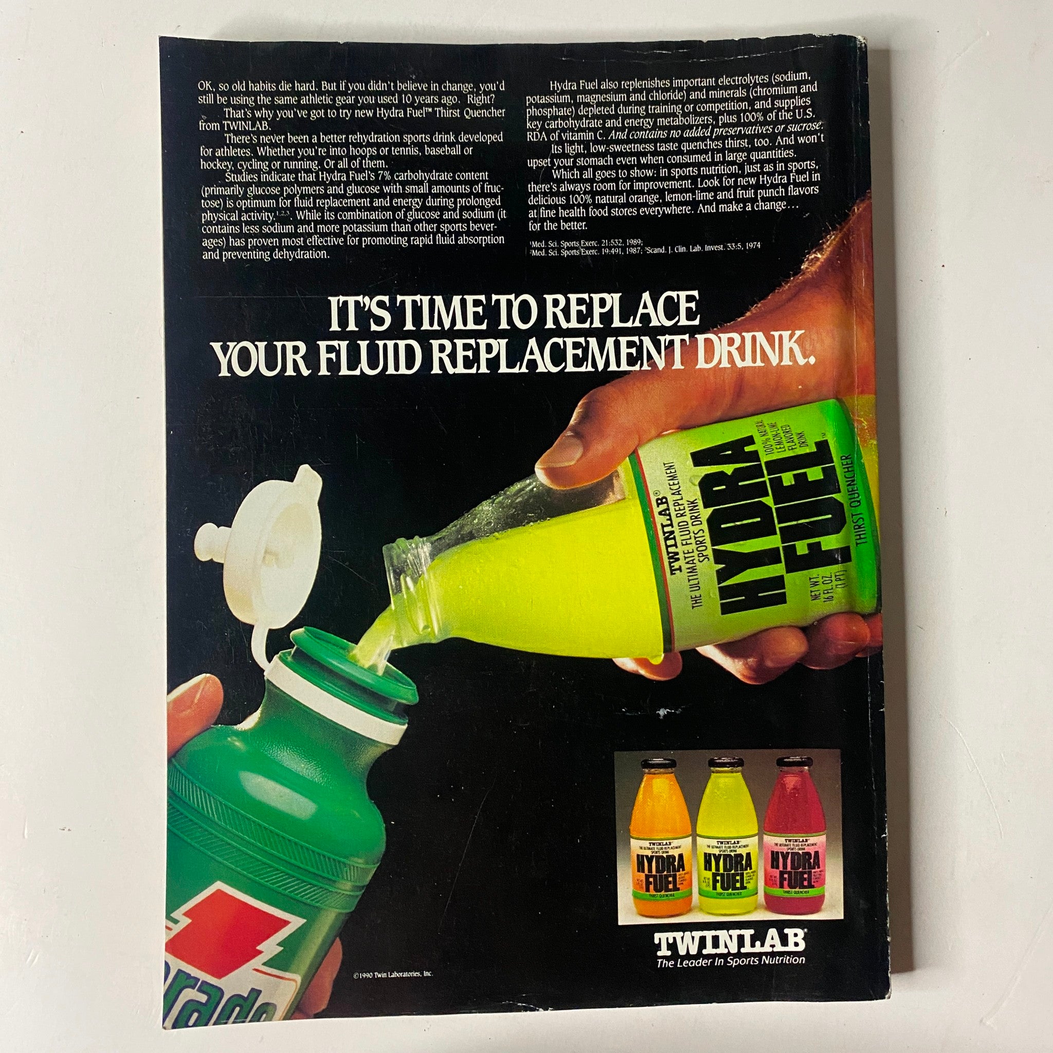 MuscleMag International Magazine December 1990 No. 103 Berry DeMey, showcasing an advertisement for Hydra Fuel, a fluid replacement drink, highlighting its vivid packaging and usage instructions.