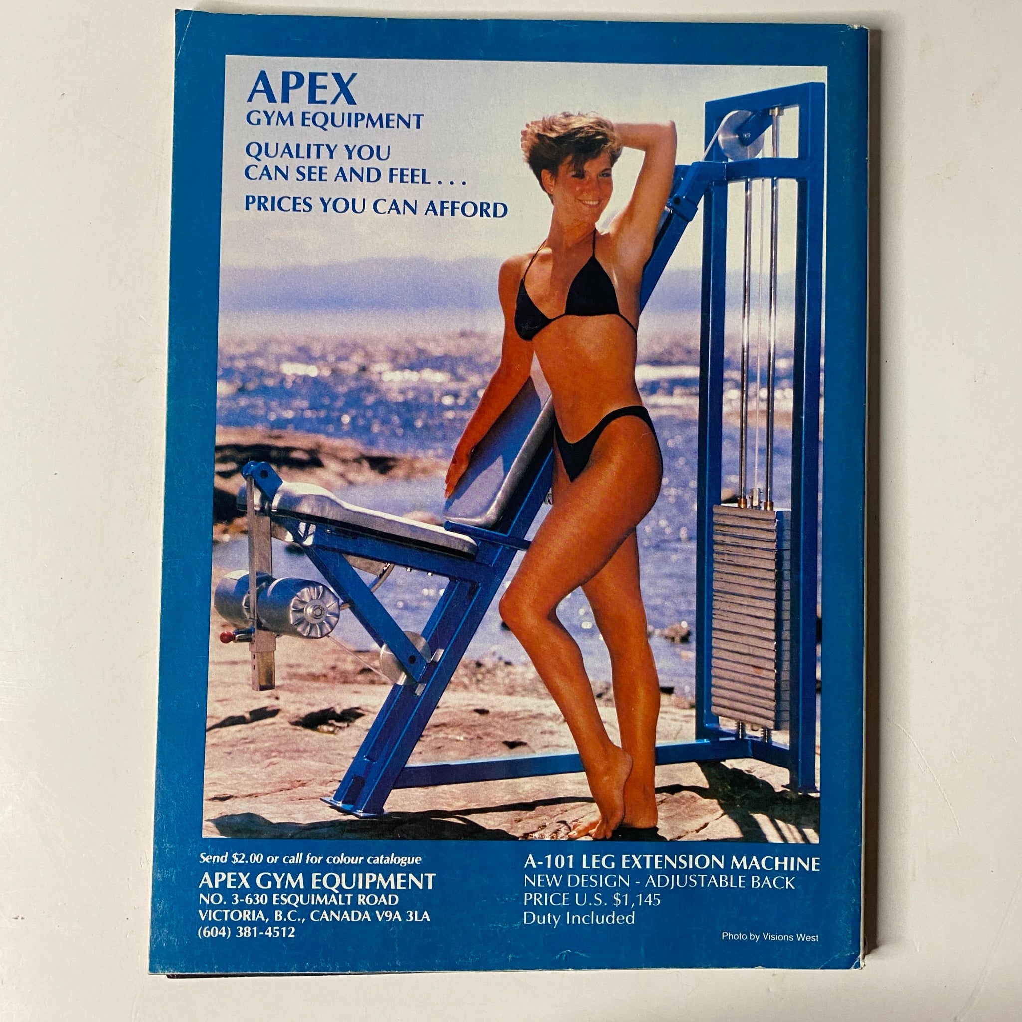 Back cover of MuscleMag International Magazine January 1990 No. 92 advertising Apex Gym Equipment with a model demonstrating fitness gear.
