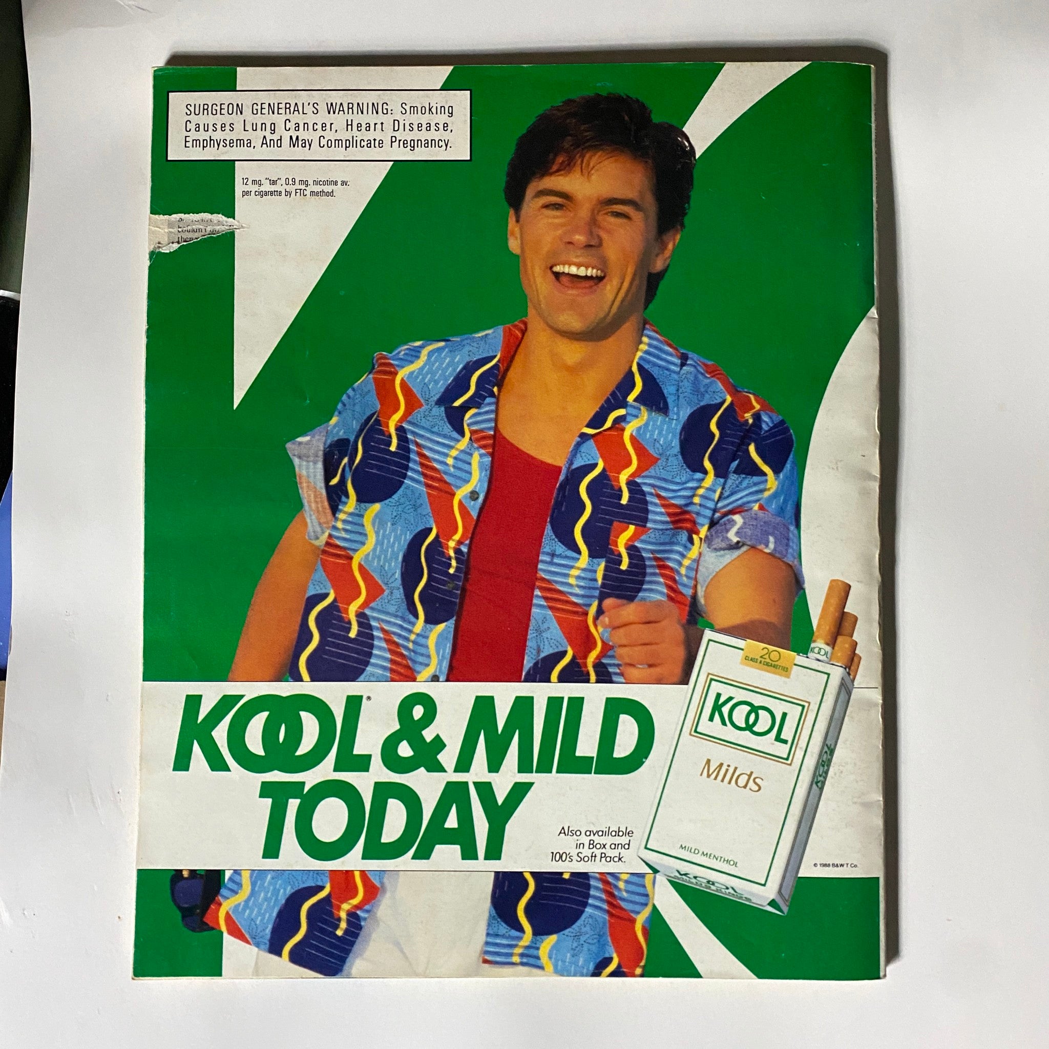 Advertisement page in Dick Vitale's Basketball Magazine 1988-1989 featuring a cheerful model promoting Kool & Mild cigarettes.