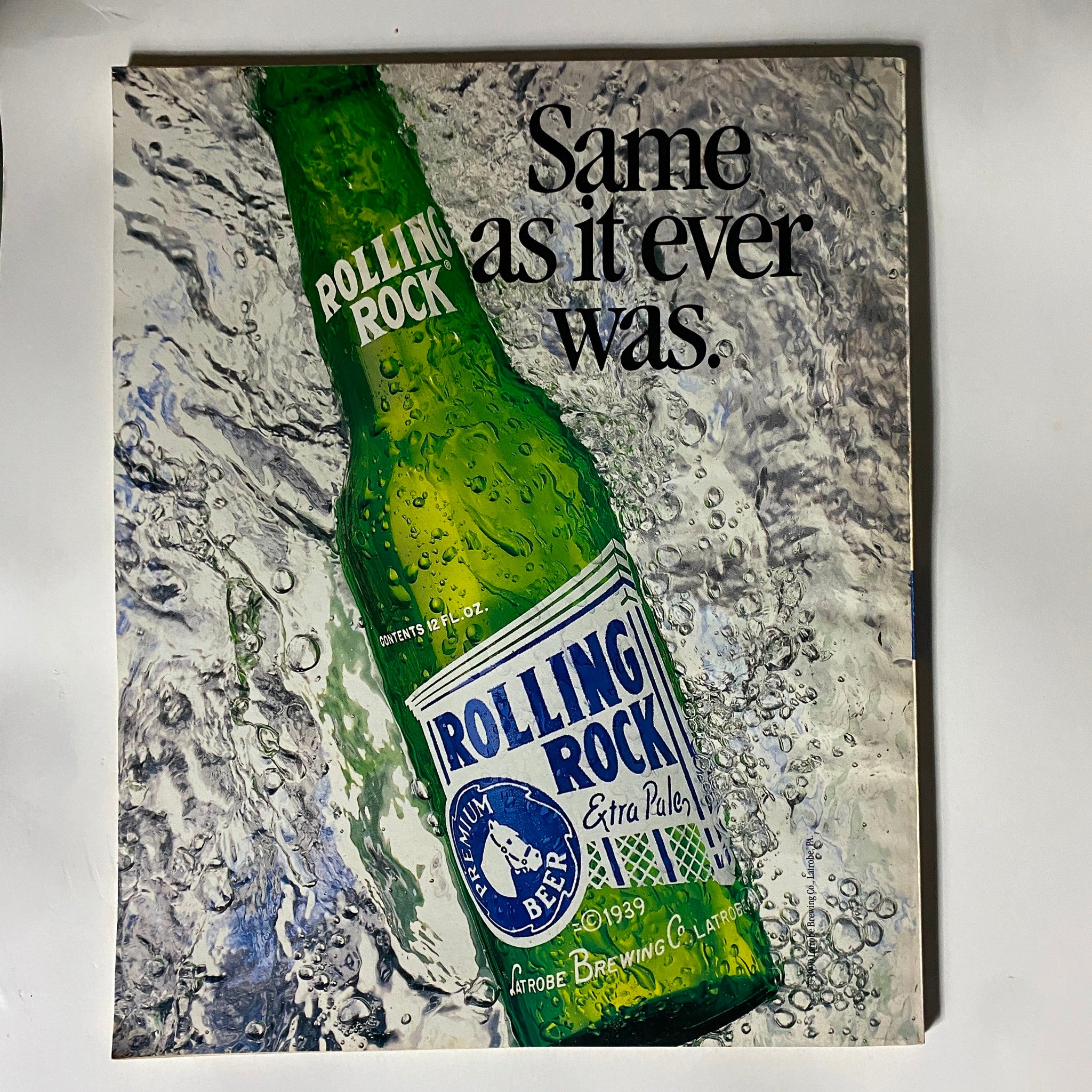 Cover of Dick Vitale's College Basketball Magazine 1993-1994 showcasing a Rolling Rock beer advertisement with the phrase 'Same as it ever was' alongside a vividly illustrated beer bottle, reflecting the nostalgic aesthetic of the era.
