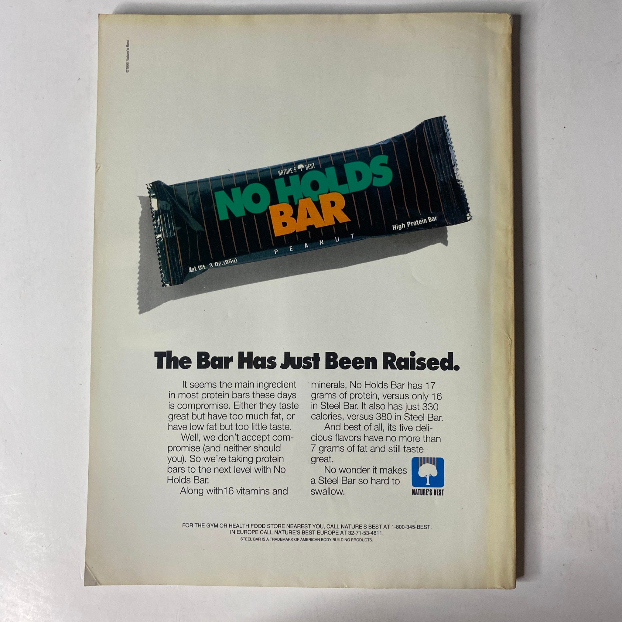 Back cover of MuscleMag International Magazine January 1997 No. 175, displaying an advertisement for No Holds Bar protein bars, highlighting their high protein content.