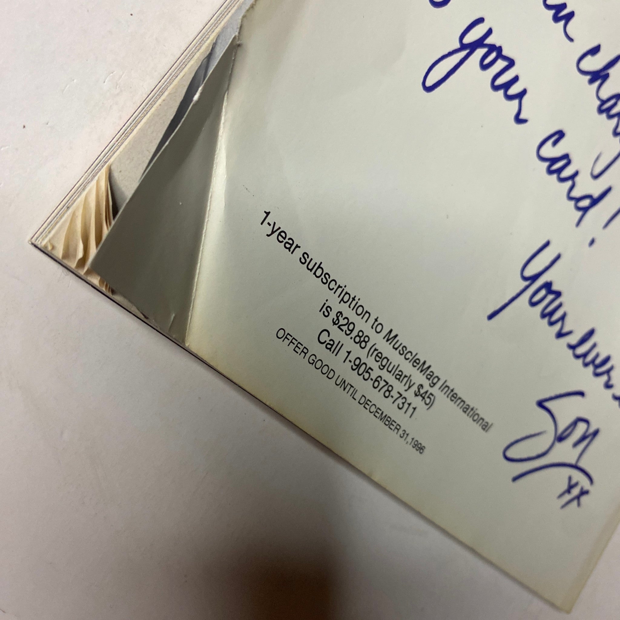 Close-up of the back cover of MuscleMag International Magazine February 1997 featuring a subscription offer and handwritten note. This vintage bodybuilding magazine features Mike O'Hearn and Amy Fadhli on the cover.