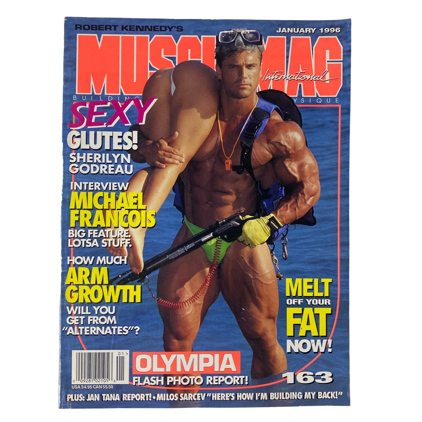 MuscleMag International Magazine January 1996, Issue #163 featuring a muscular man on the cover holding a weapon, promoting bodybuilding and fitness with articles on sexy glutes and arm growth.
