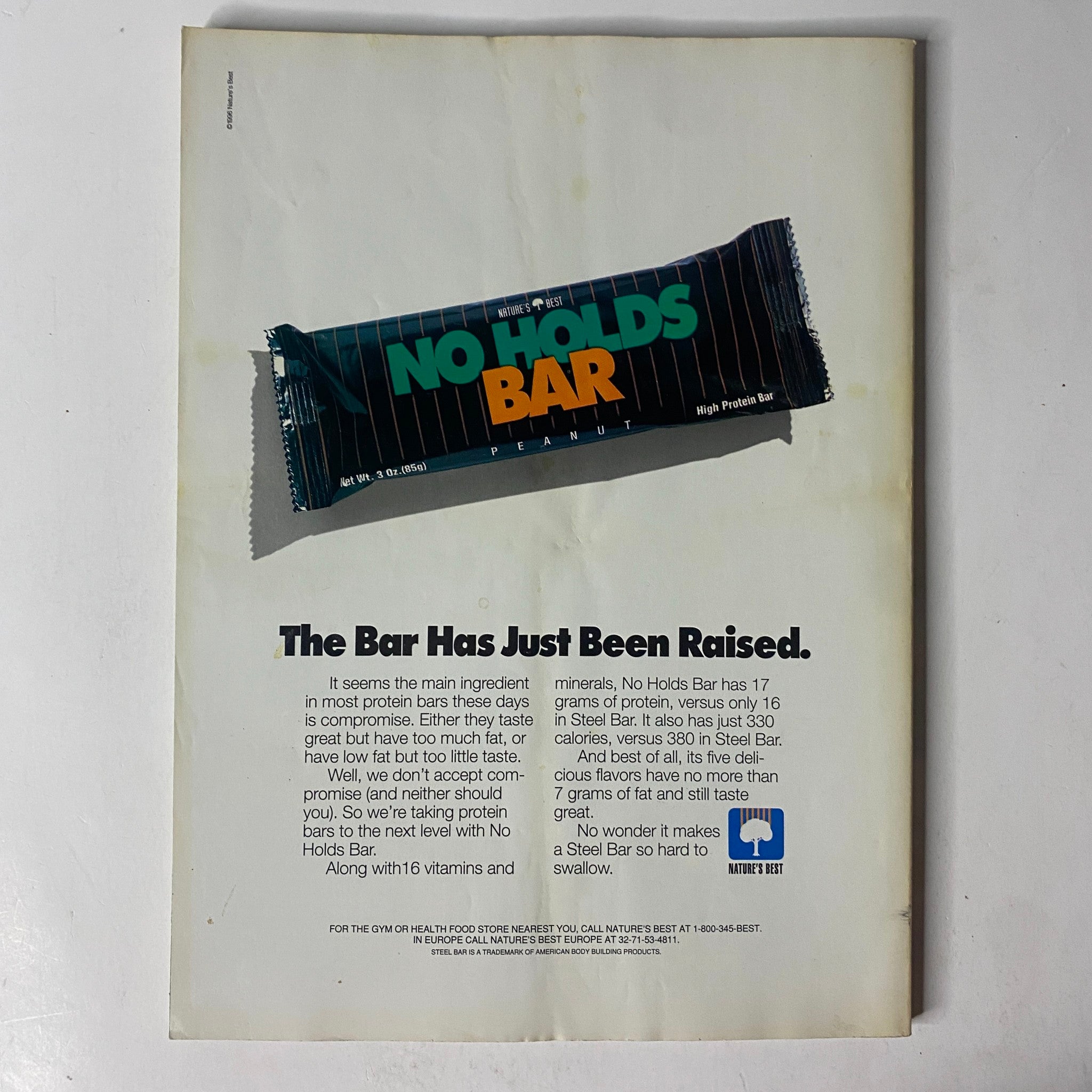 Back cover of MuscleMag International Magazine December 1996 advertising a high-protein snack bar, emphasizing health and nutrition.