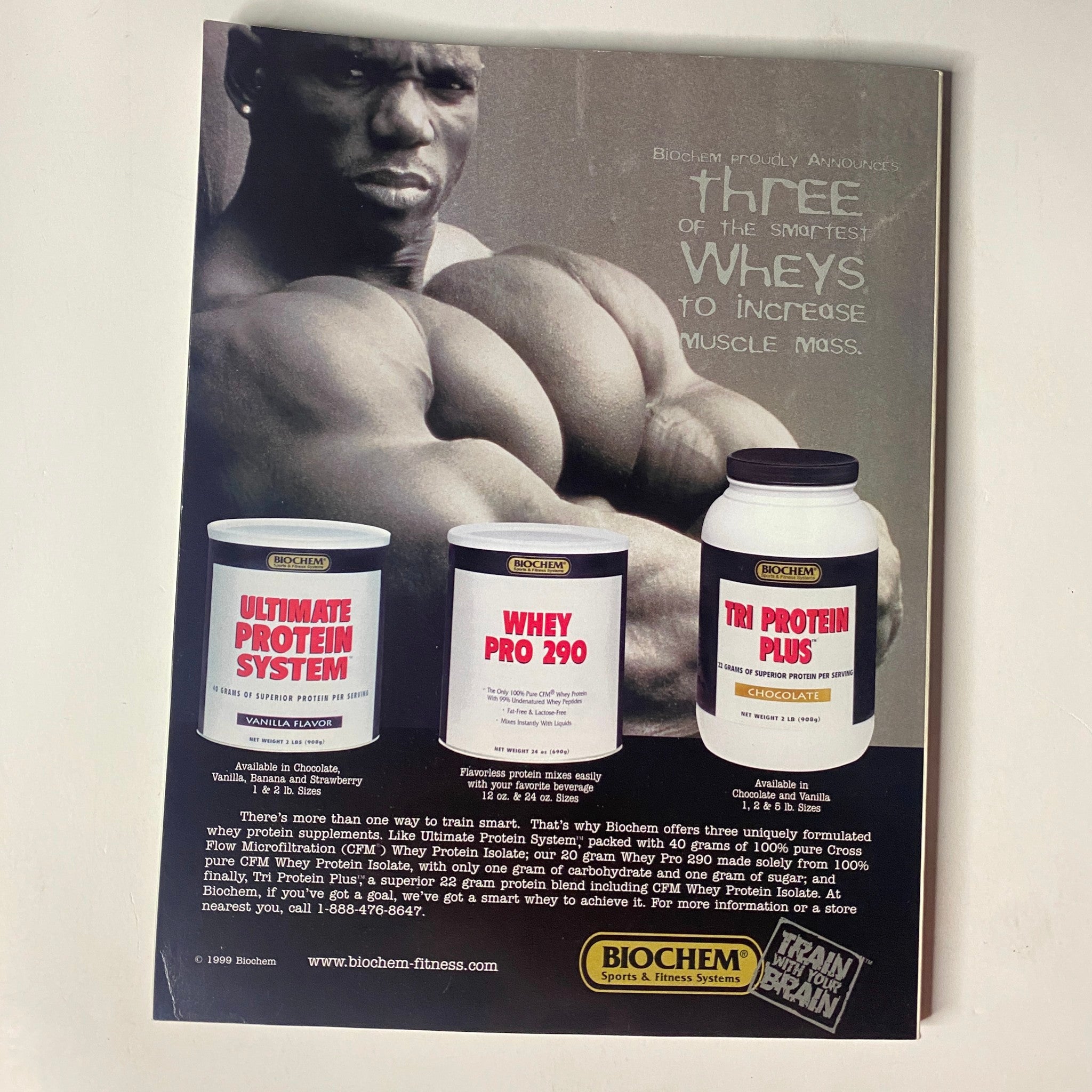 Muscle & Fitness Magazine September 1999 featuring protein supplements from Biochem Sports and Fitness. The image showcases three types of whey protein products: Ultimate Protein System, Whey Pro 290, and Tri Protein Plus, aimed at increasing muscle mass. Ideal for fitness enthusiasts and bodybuilders.