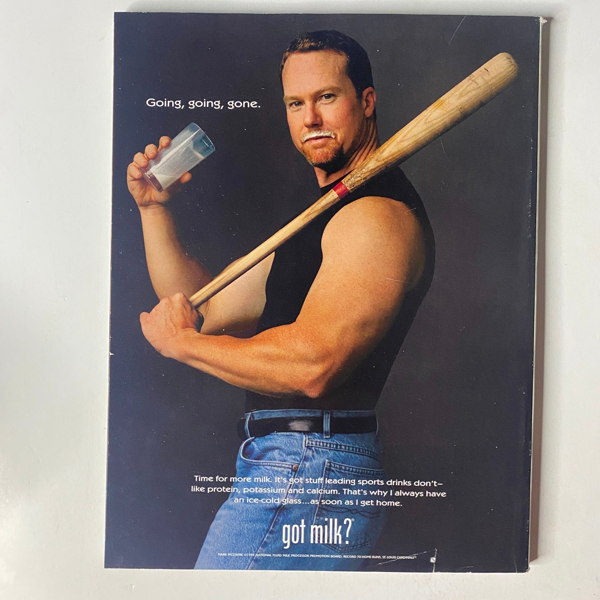 Got Milk? advertisement featuring a muscular man holding a glass of milk and a baseball bat, emphasizing nutrition through the lens of Muscle & Fitness Magazine May 1999.