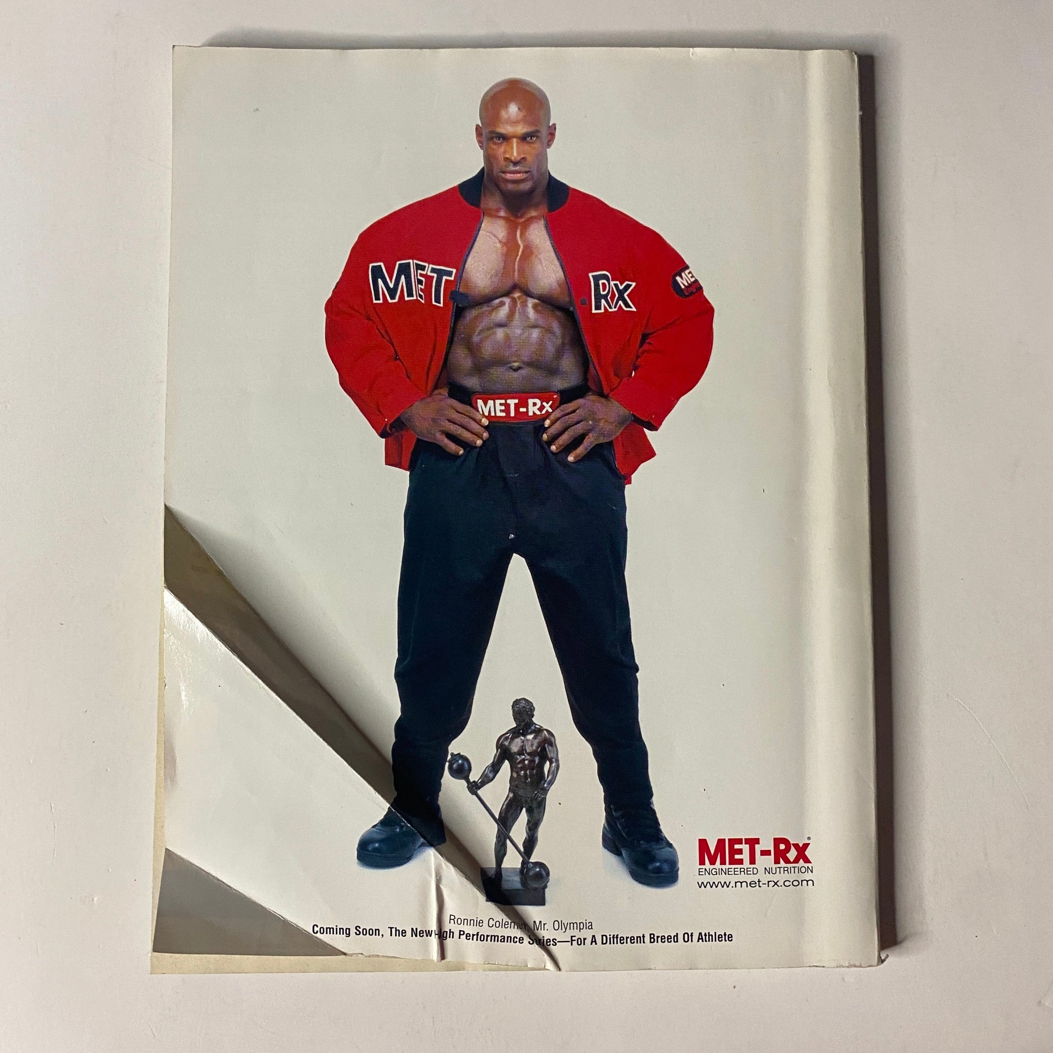 Advertisement for MET-Rx featuring bodybuilder with a muscular physique, showcased in Muscle & Fitness Magazine January 1999.