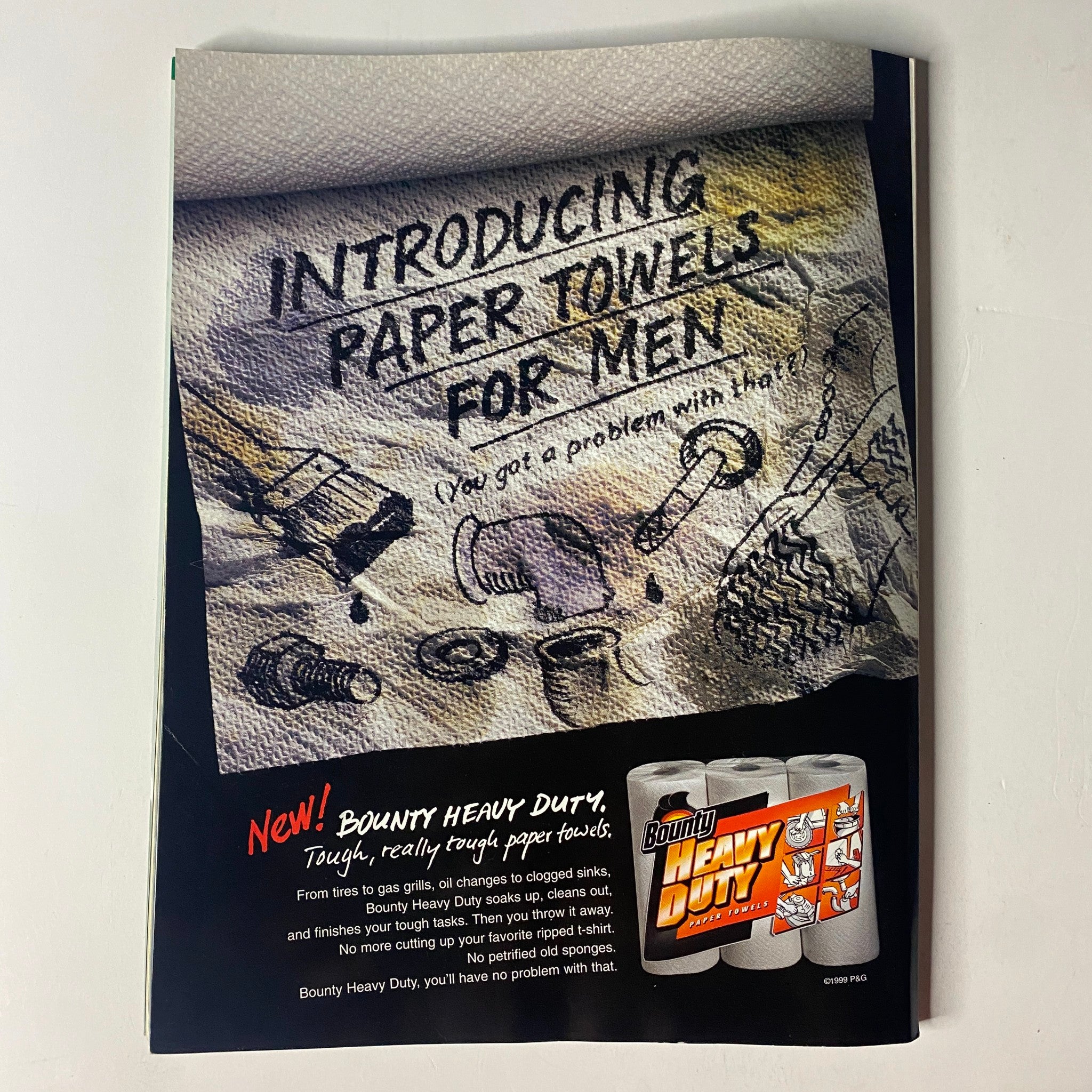 Advertisement for Bounty Heavy Duty paper towels featured in Muscle & Fitness Magazine November 1999, promoting toughness and reliability.