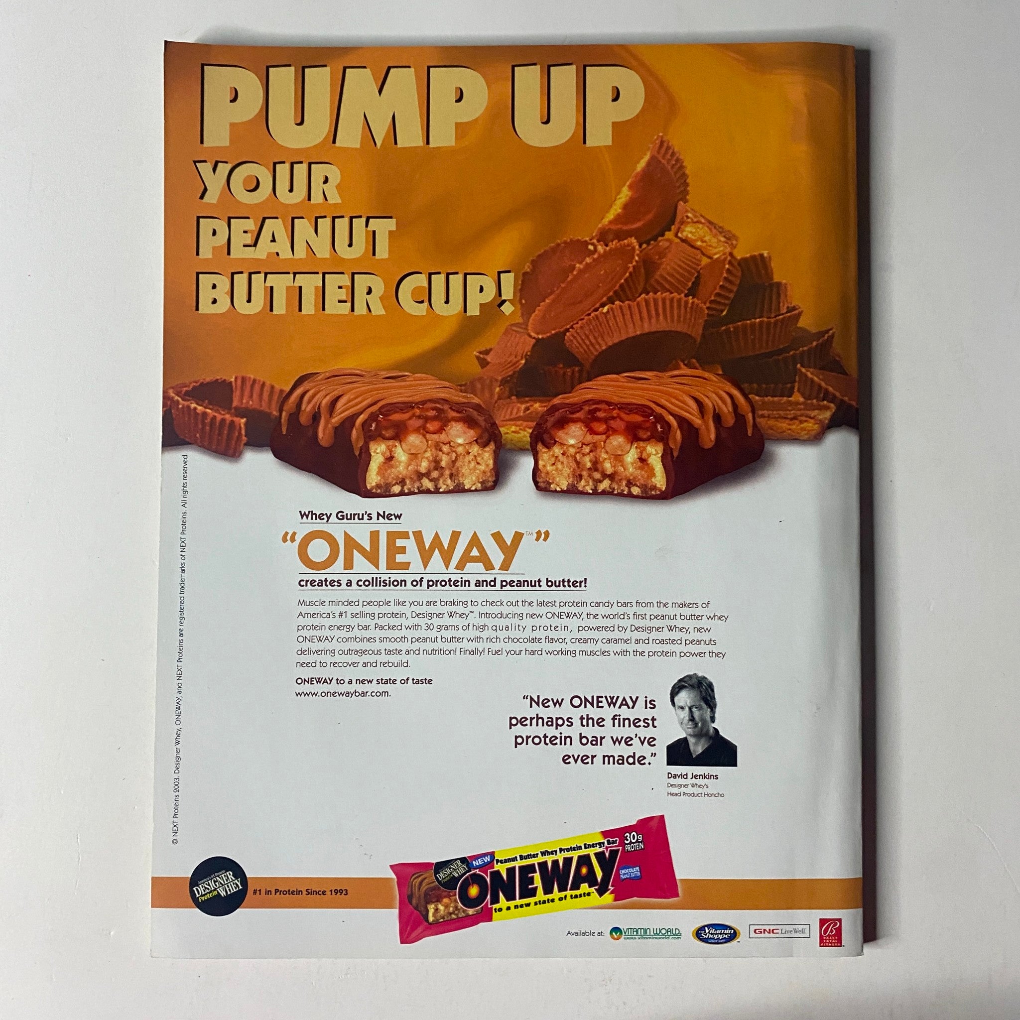 Pump Up Your Peanut Butter Cup advertisement featuring Whys Guys' new protein bar 'ONEWAY'. Promote muscle growth and nutrition with this enticing product, highlighted in the September 2003 issue of Muscle & Fitness Magazine, Vol 64 No. 9.