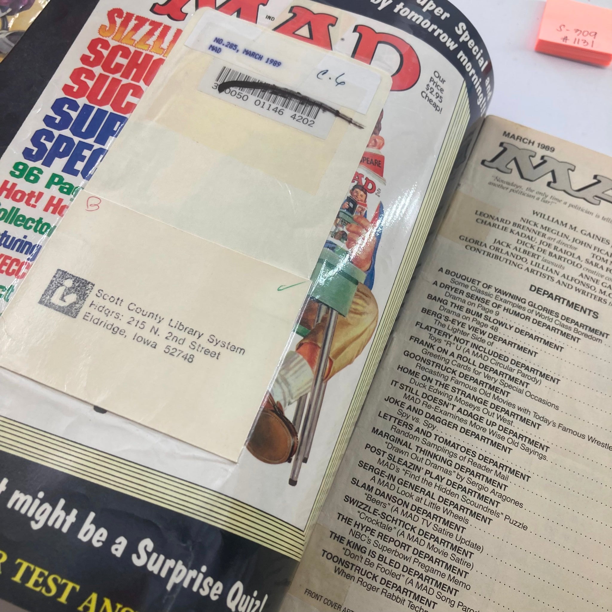 Interior view of Mad Magazine March 1989 No. 285 showing pages and a library card, highlighting the vintage condition and collectible nature of the magazine.