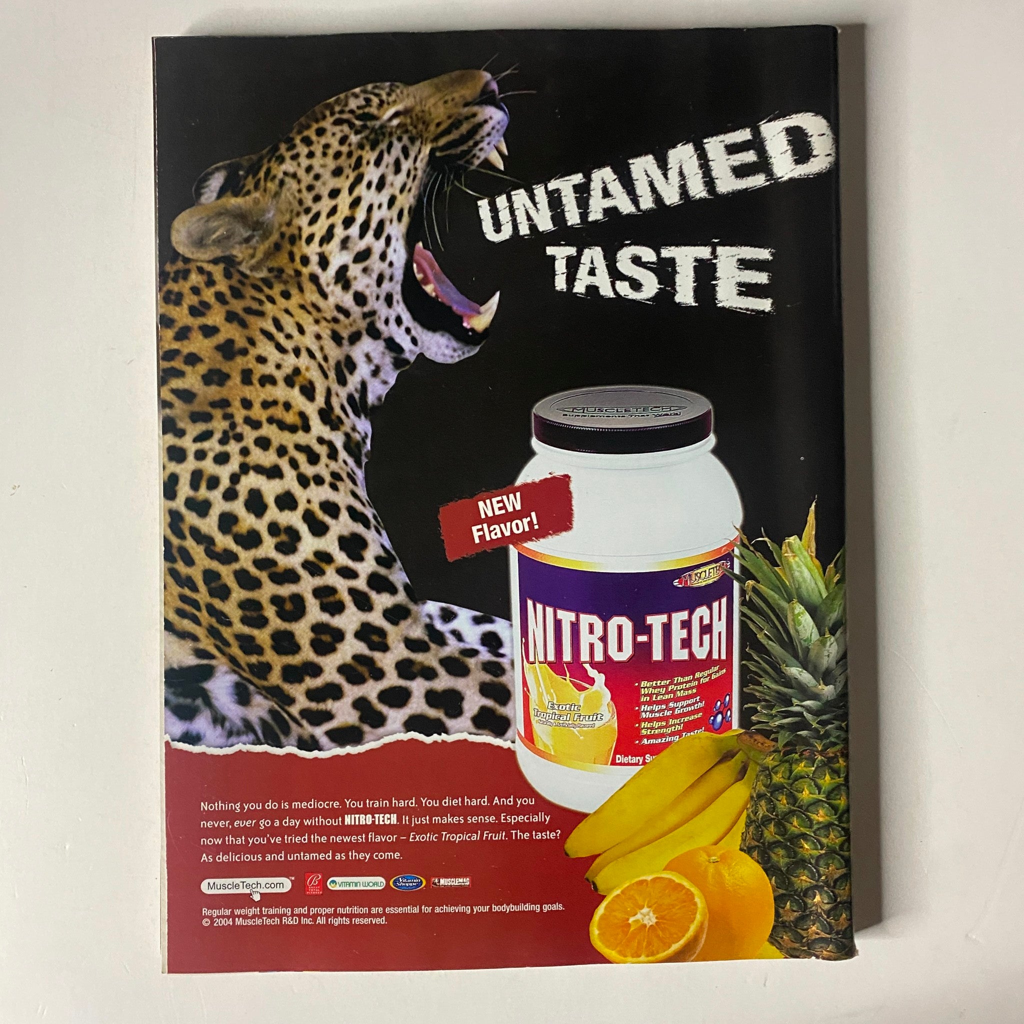 Advertisement page in MuscleMag International Magazine April 2004 for Nitrotech protein supplement, featuring a jaguar and promotional details about the product.