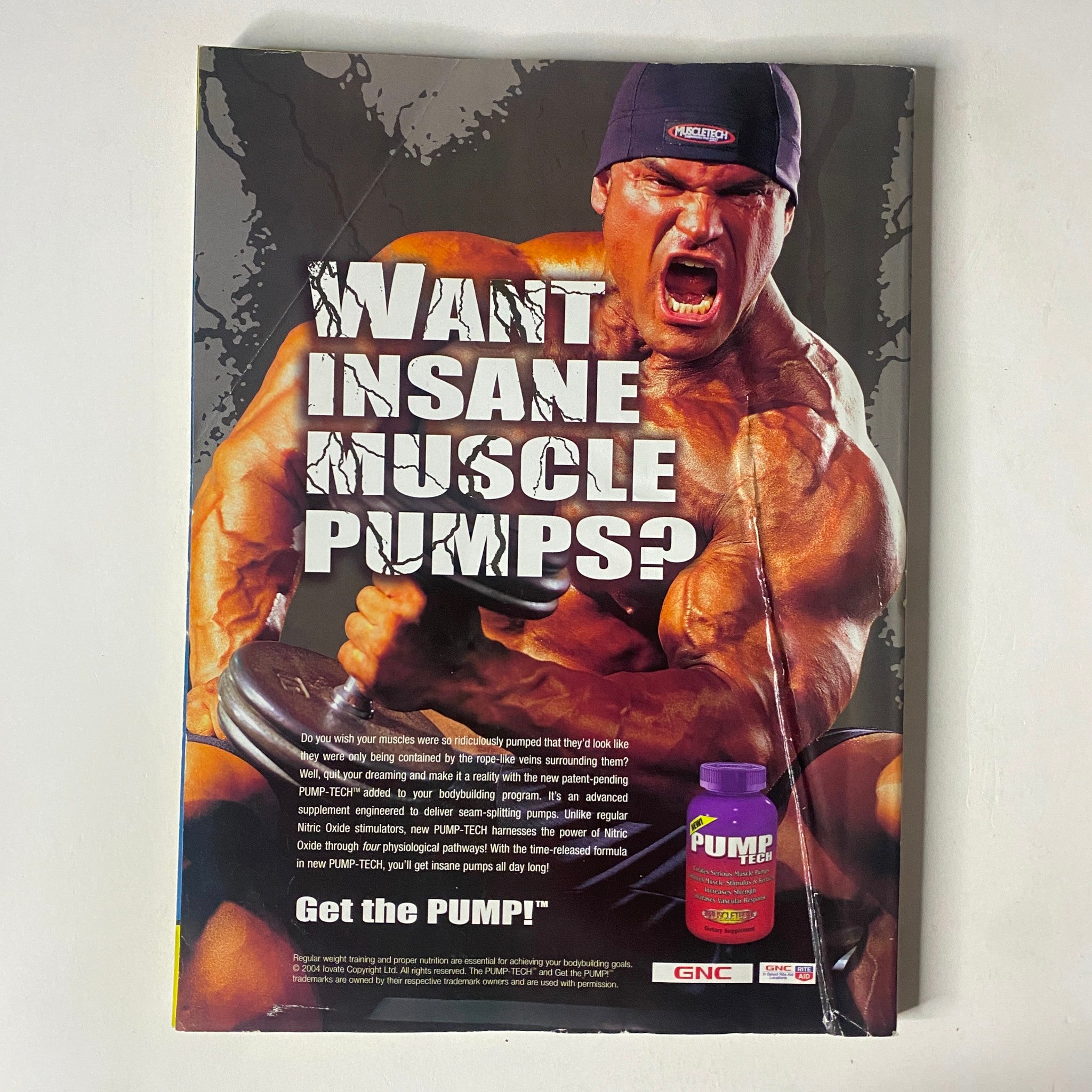 Back cover of MuscleMag International Magazine January 2005 promoting a muscle supplement with a muscular man demonstrating strength.