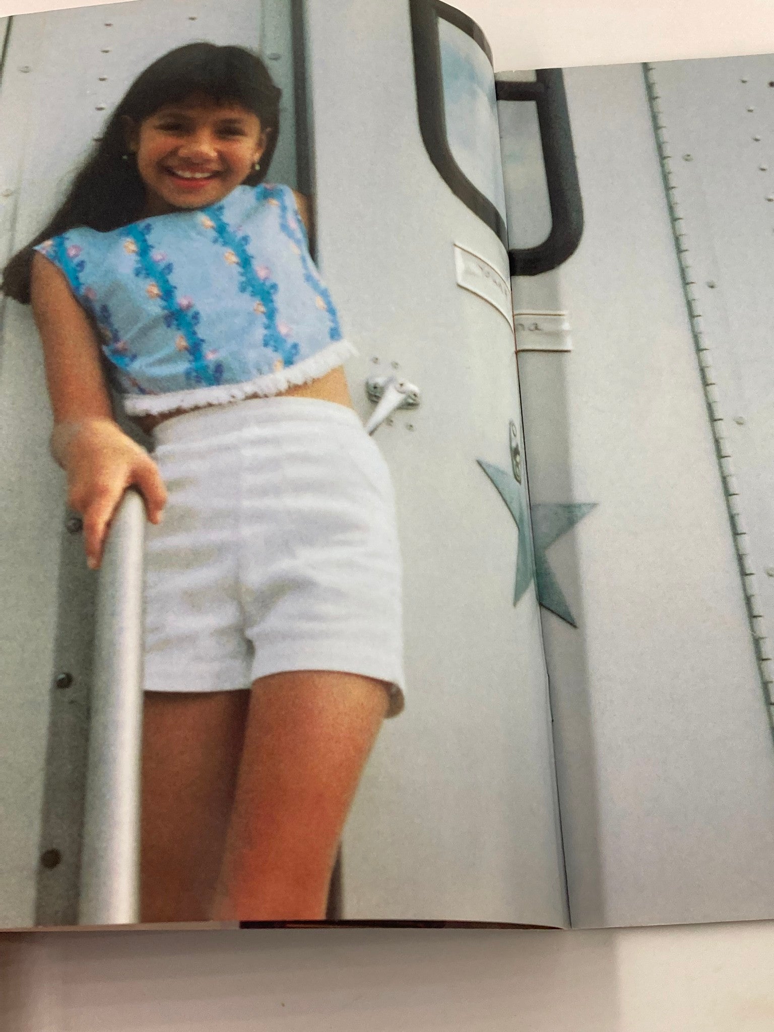 Image from the 1997 Selena Movie Special Movie Showcase Series displaying Becky Lee Meza smiling, dressed in a stylish outfit, captured while posing outdoors.