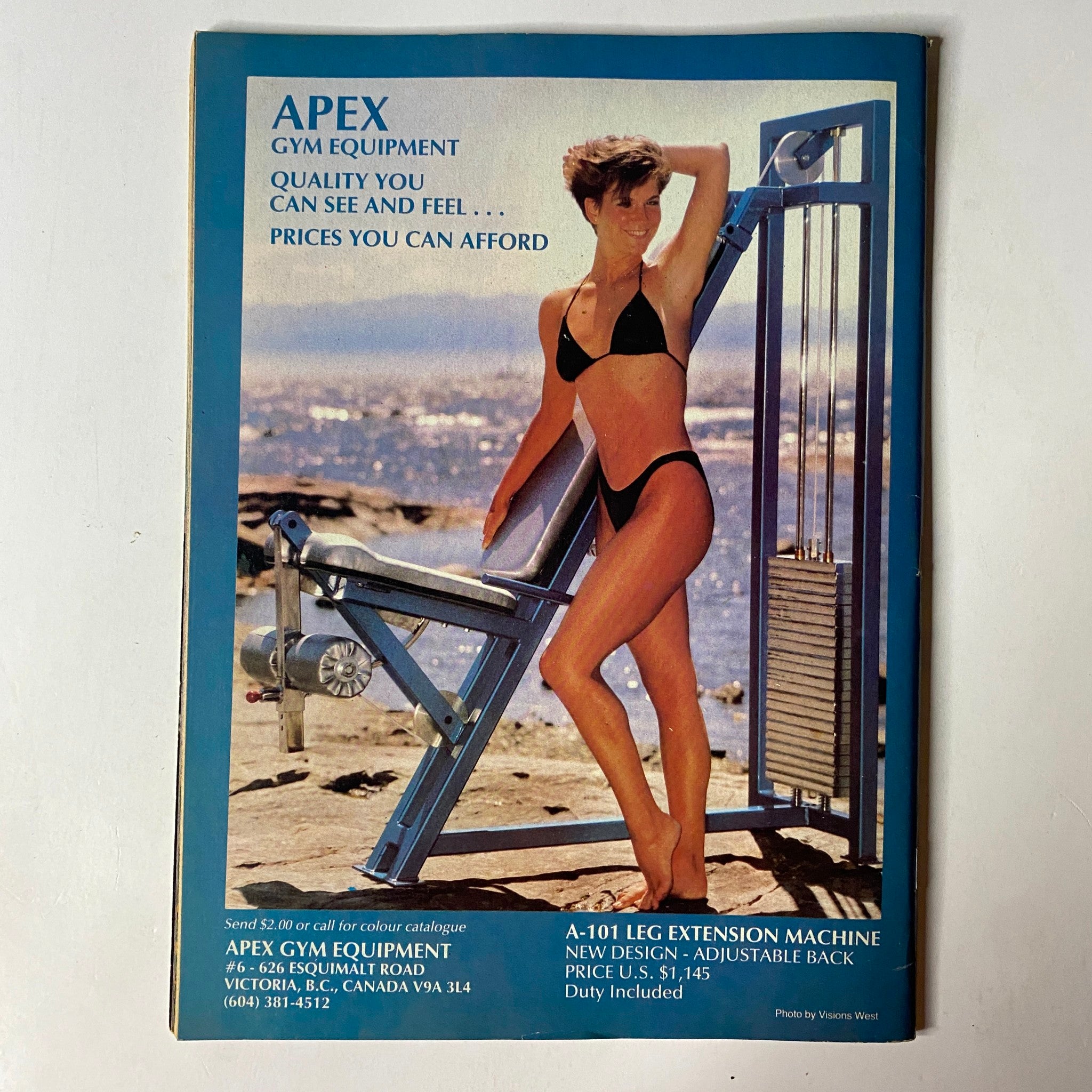 Back cover of MuscleMag International Magazine October 1986, advertising APEX gym equipment with an image of a model demonstrating fitness apparel.
