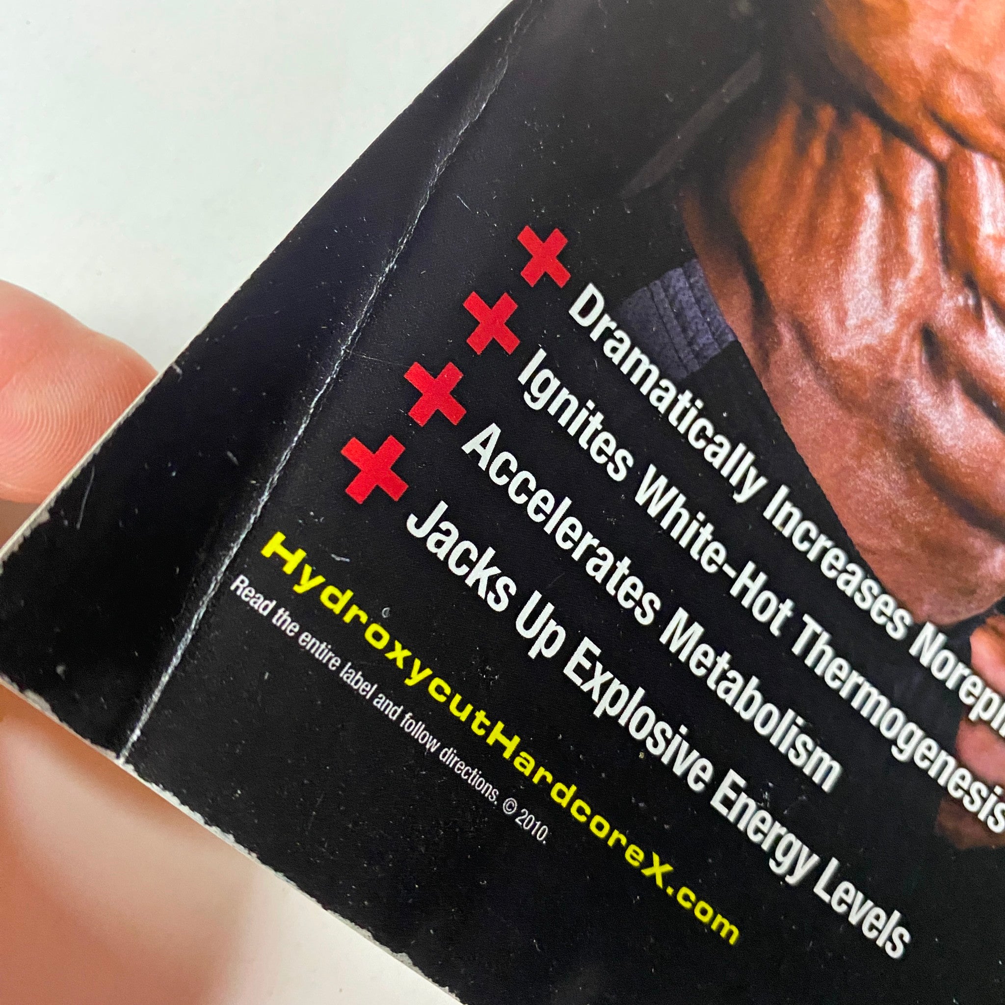 Close-up image showing the promotional content and details from the MuscleMag International Magazine May 2010, No. 336, featuring Ronnie Coleman, highlighting key product benefits such as boosting metabolism and energy levels.