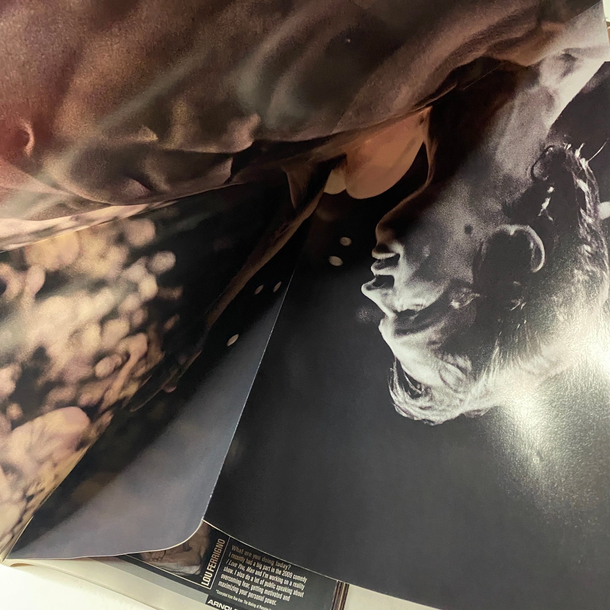 Interior image from MuscleMag International Magazine Spring 2010, highlighting Arnold Schwarzenegger in an intense training pose.