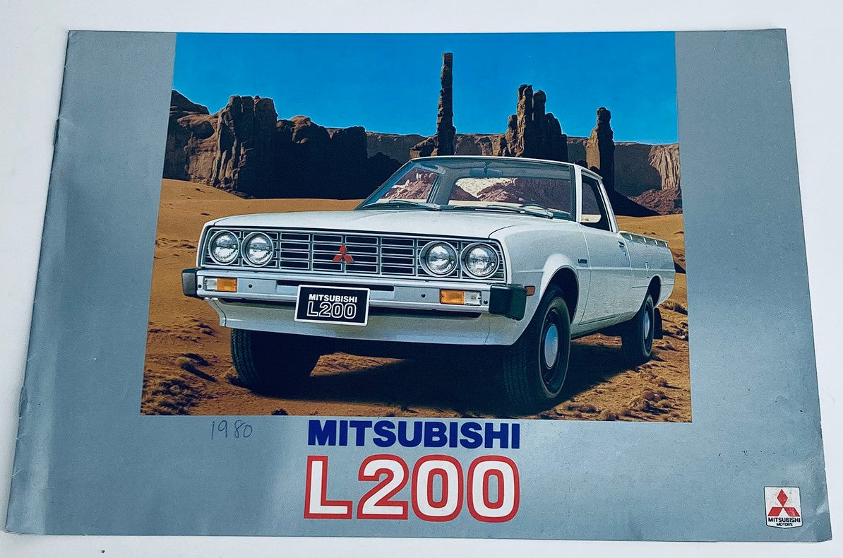 1980 Mitsubishi L200 Dealer Showroom Sales Brochure Guide Catalog featuring the white Mitsubishi L200 truck in a desert landscape background, showcasing its design and features.