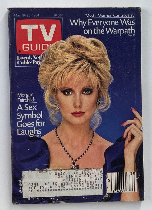 TV Guide Magazine May 19, 1984 featuring Morgan Fairchild, showcasing her as a glamorous sex symbol, with an elegant blue dress and a striking hairstyle, reflecting 1980s television culture.